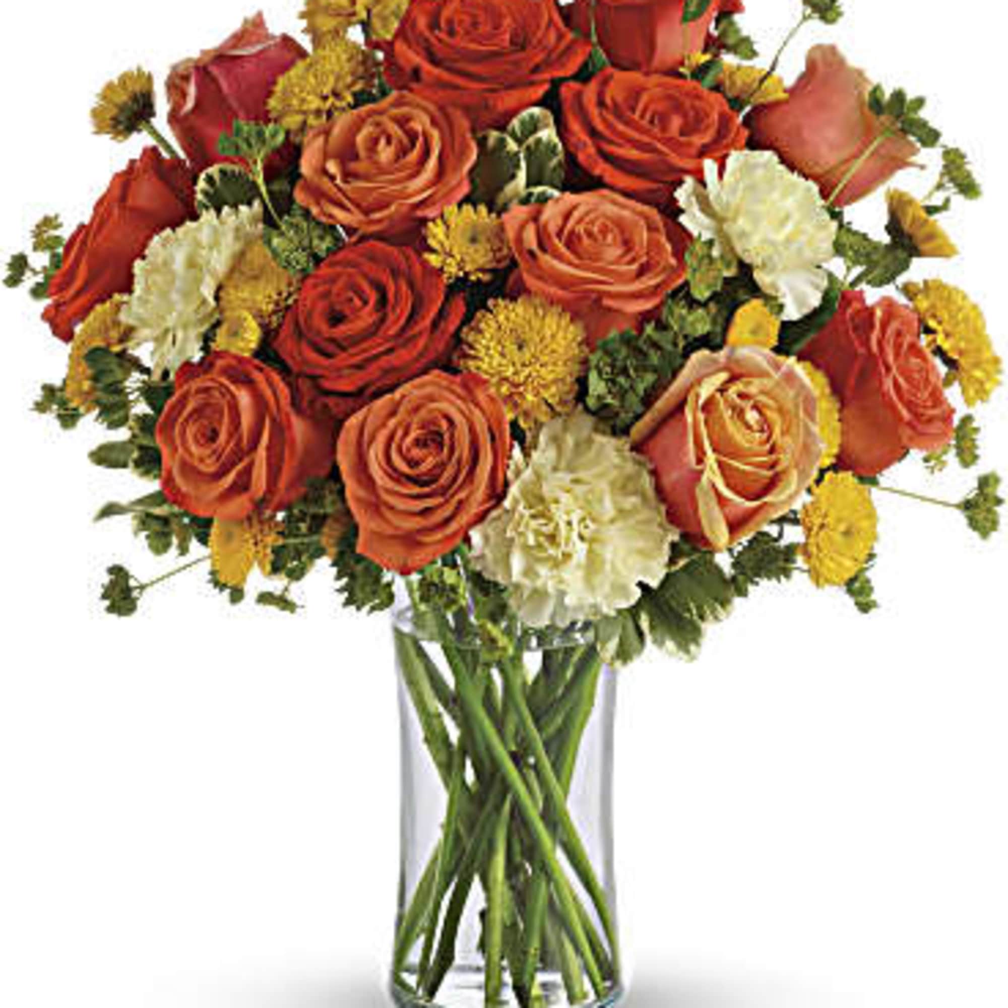 Bouquet of orange and red roses in a clear glass vase
