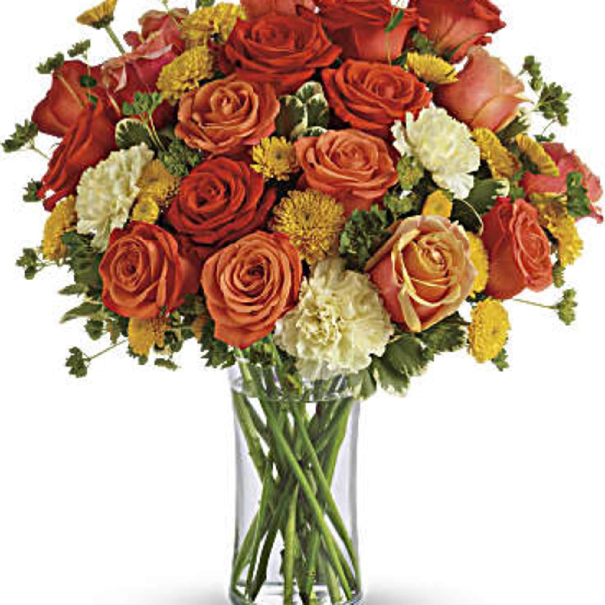 Bouquet of orange and red roses in a clear glass vase