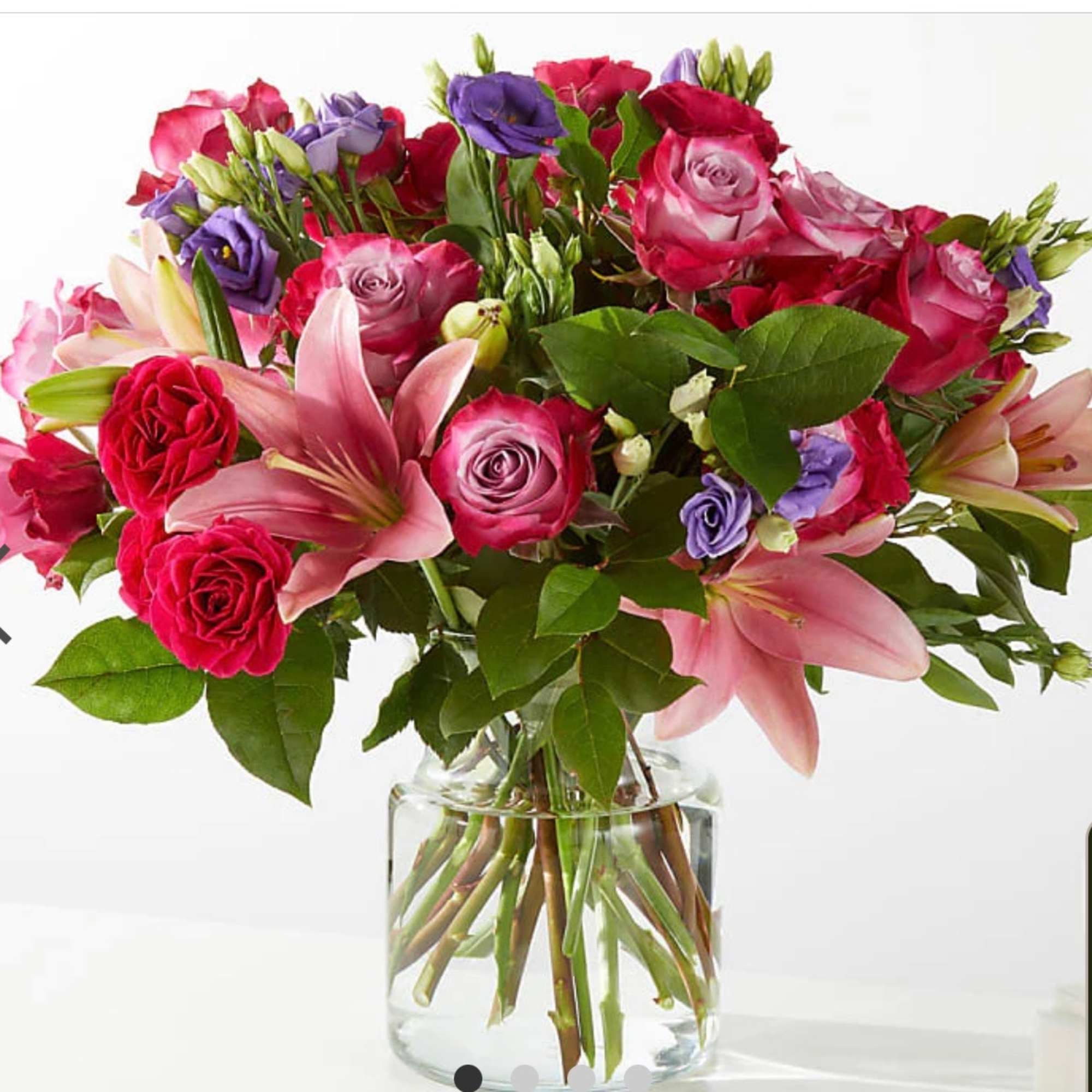 Mixed pink and purple bouquet in a clear glass vase