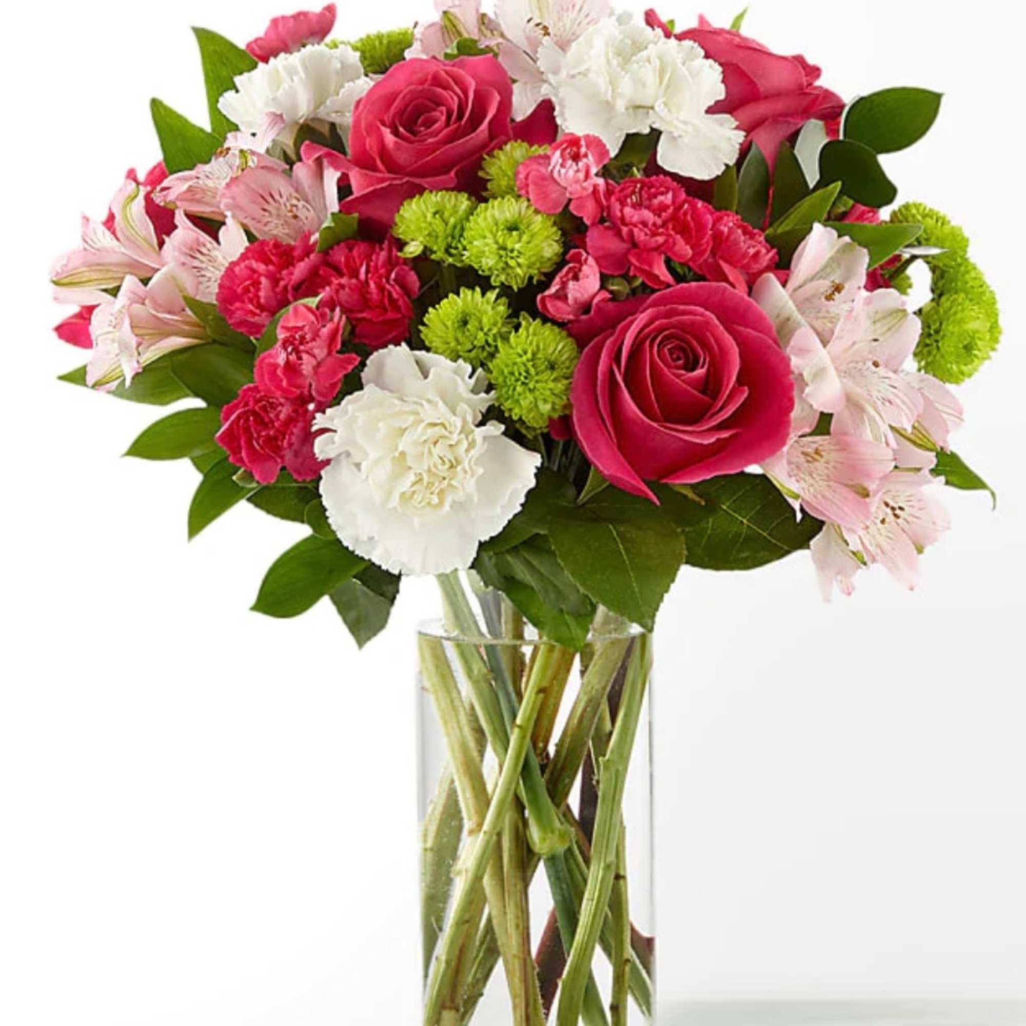 Bouquet of pink roses, carnations, and lilies in a clear glass vase