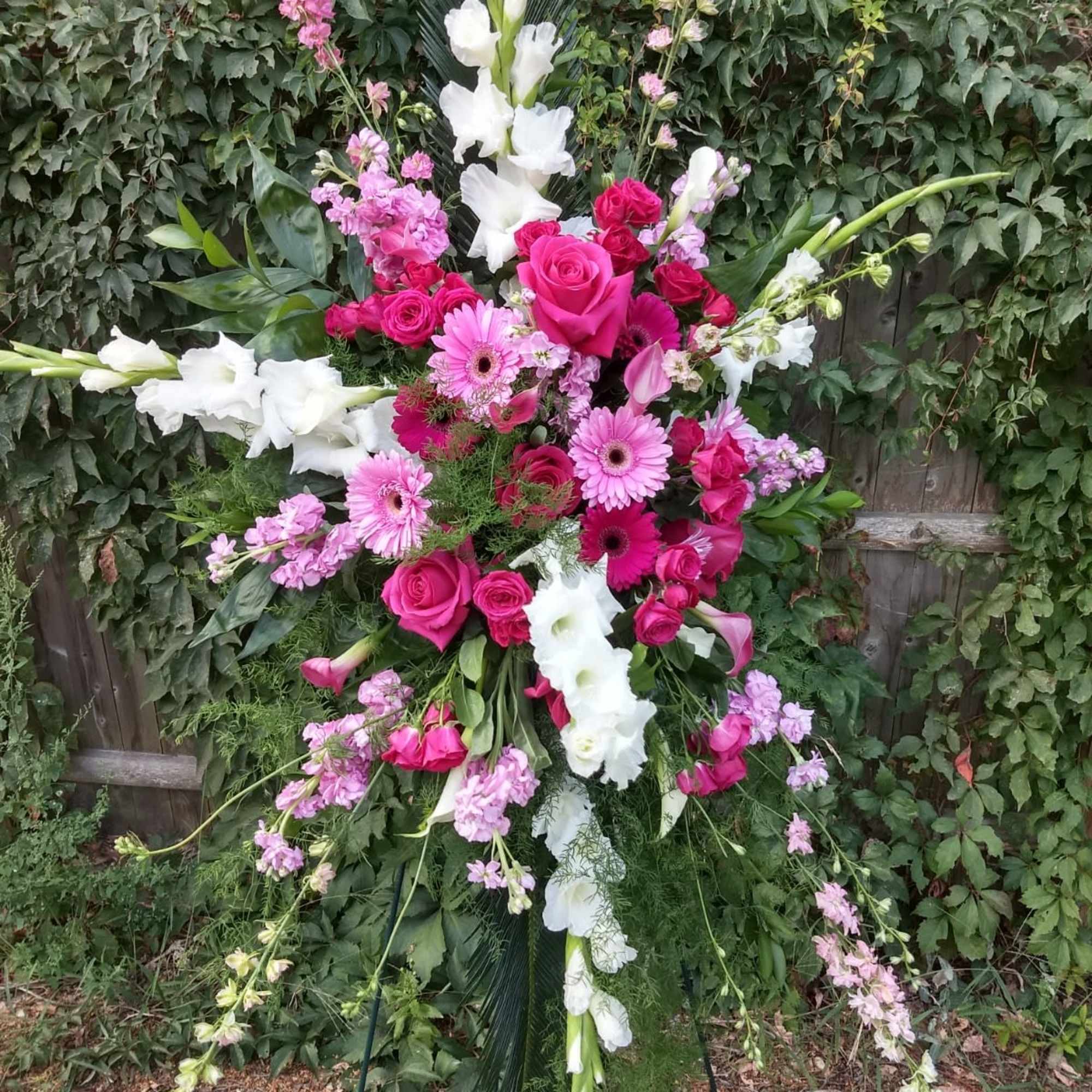 Tall pink and white floral standing spray on an easel