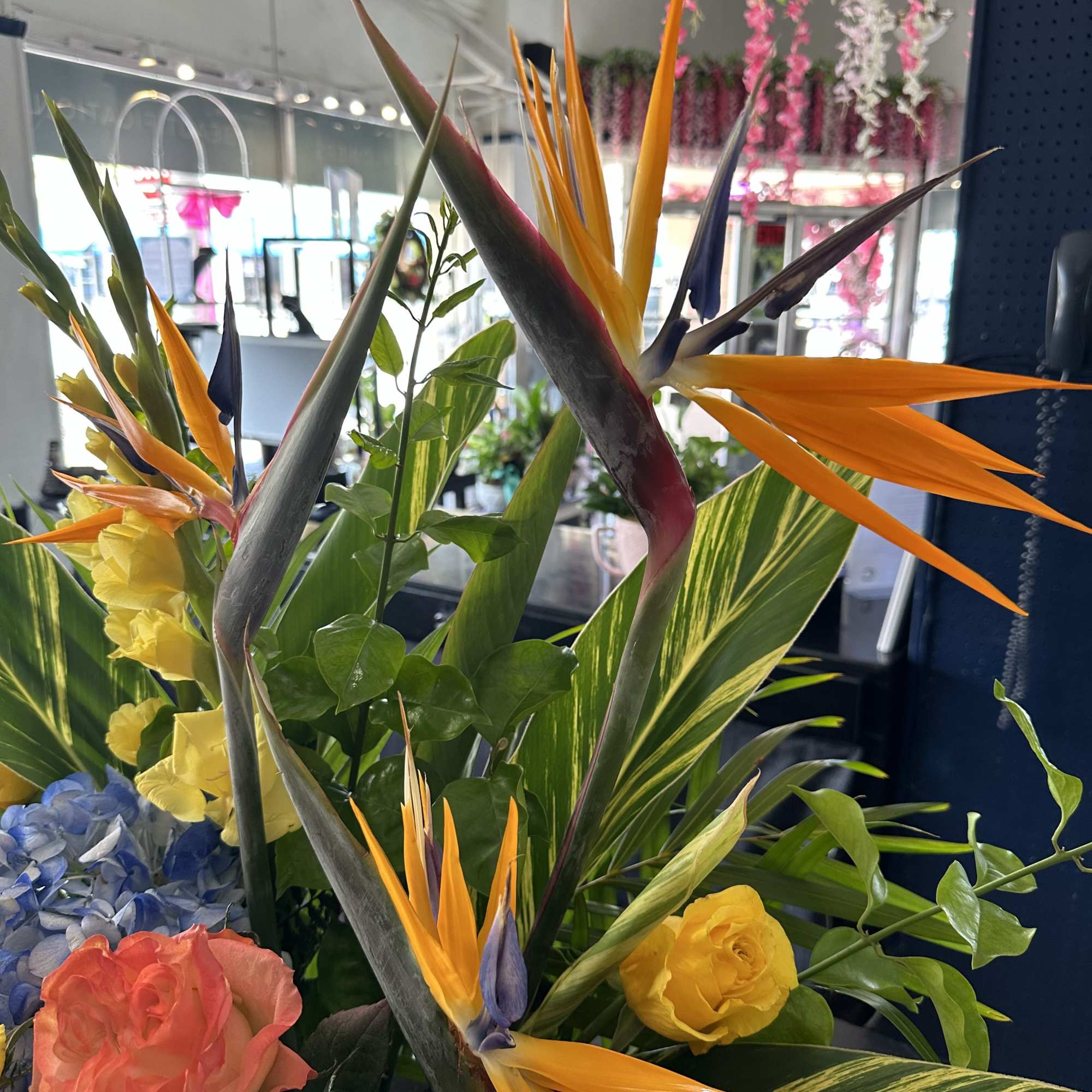 Tropical bouquet with orange bird-of-paradise and mixed blooms