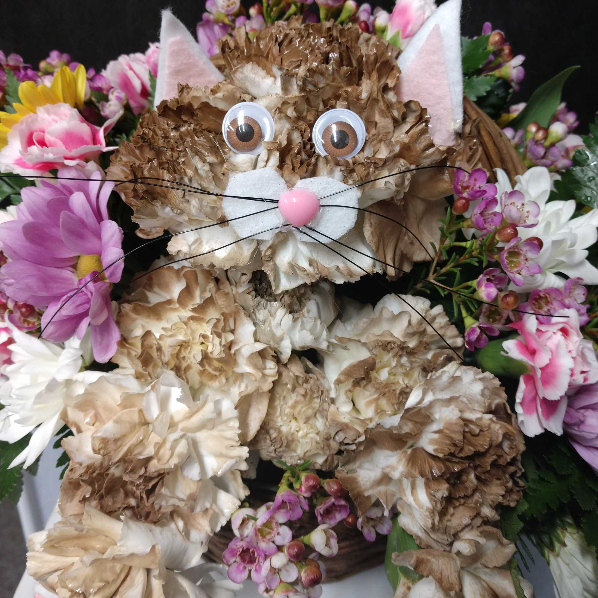 Cat-shaped floral arrangement with pink and white flowers
