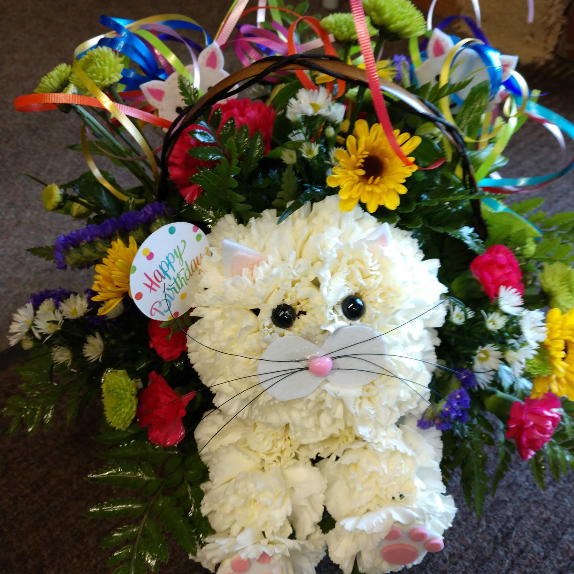 Flower basket arranged as a white bunny with colorful blooms and ribbons