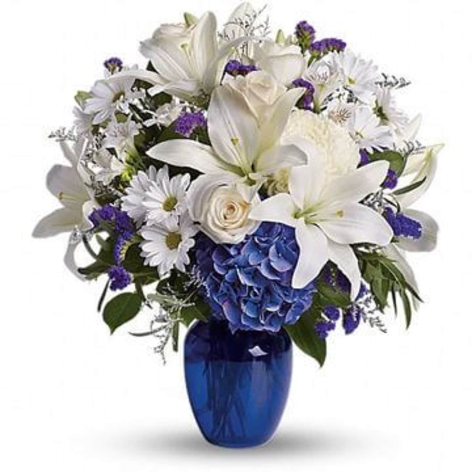 White lilies and daisies in a blue vase with purple accents