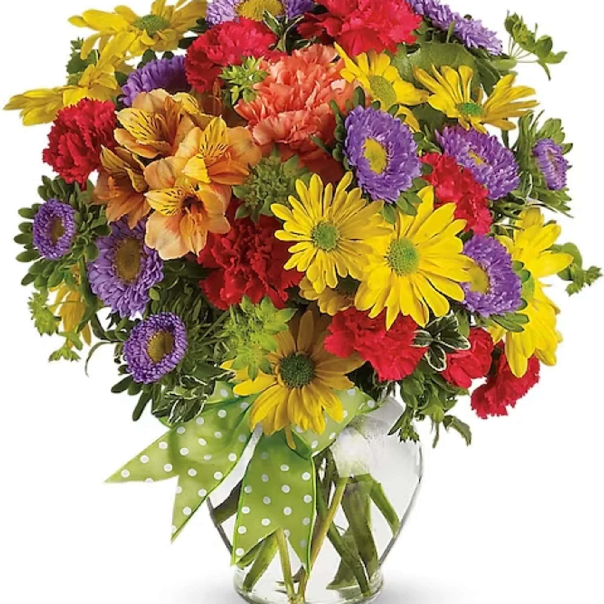Colorful bouquet of daisies and carnations in a glass vase with a green polka-dot ribbon