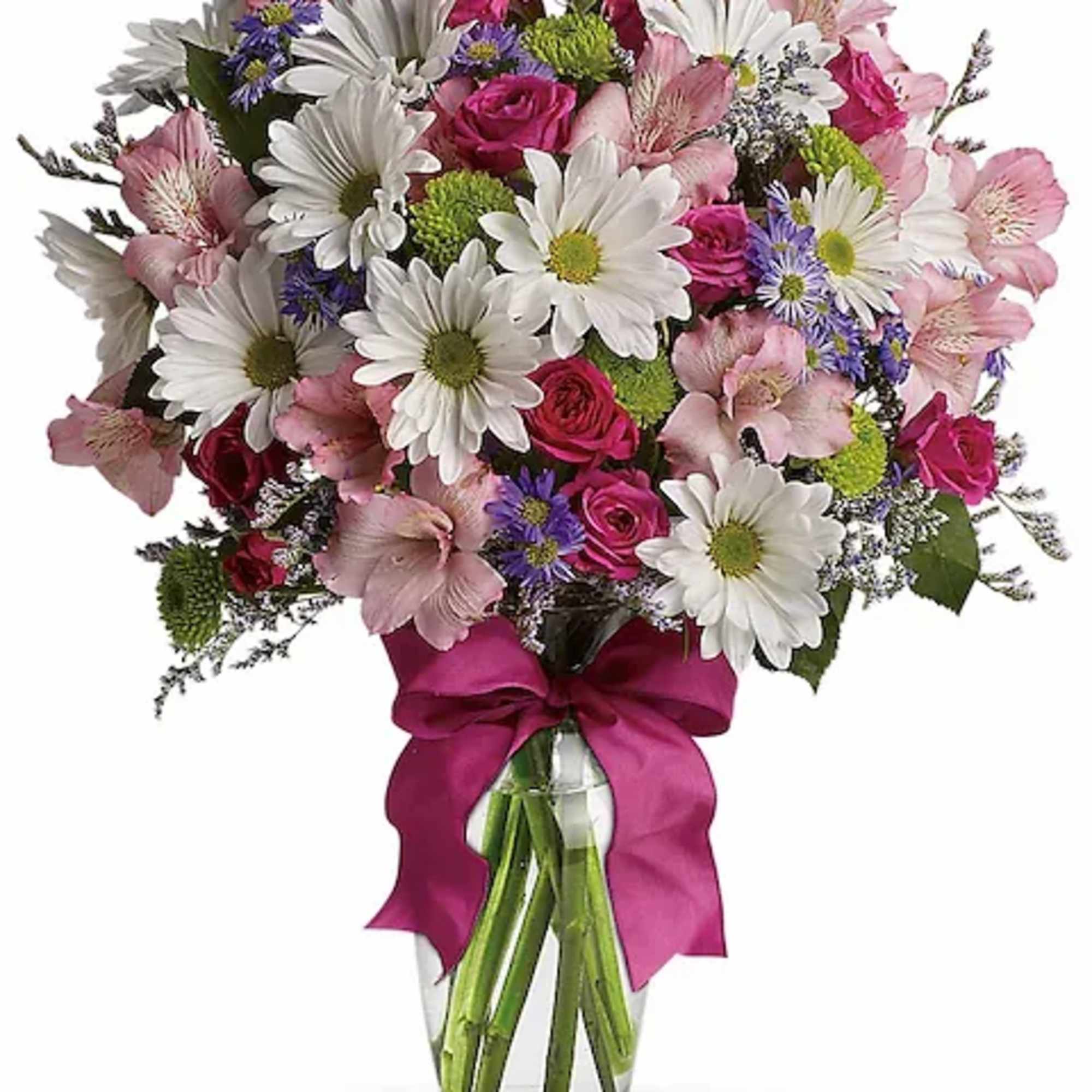 Bouquet of pink and white flowers in a clear glass vase with a magenta ribbon
