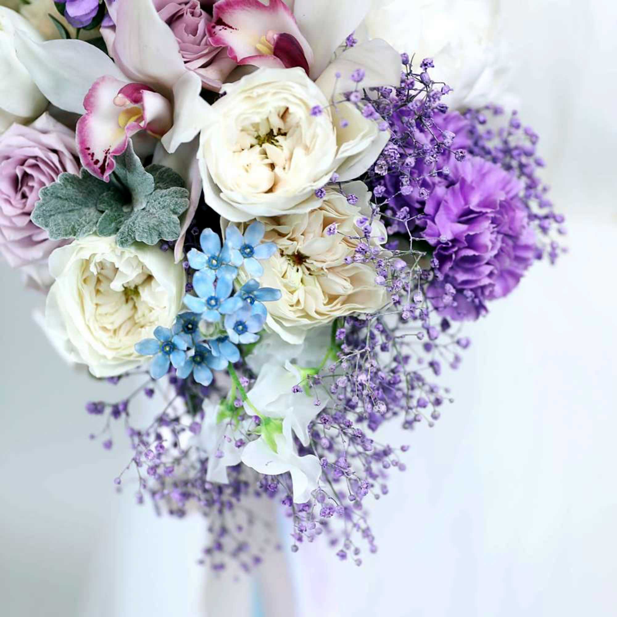 Bouquet of white and purple flowers with blue accents