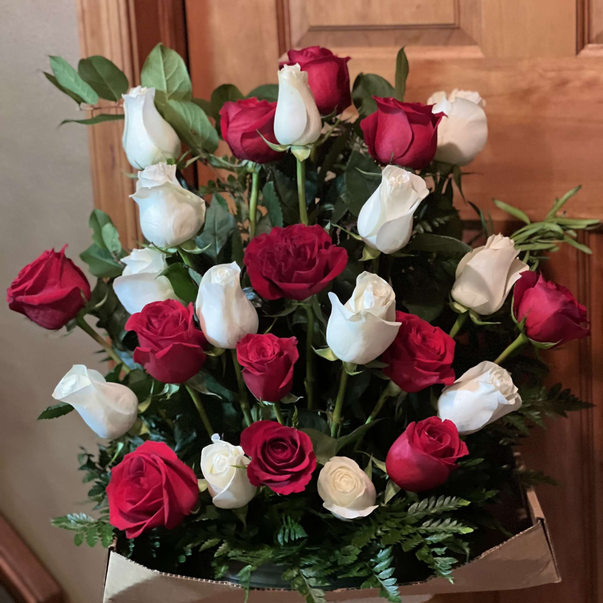 Bouquet of red and white roses in brown paper