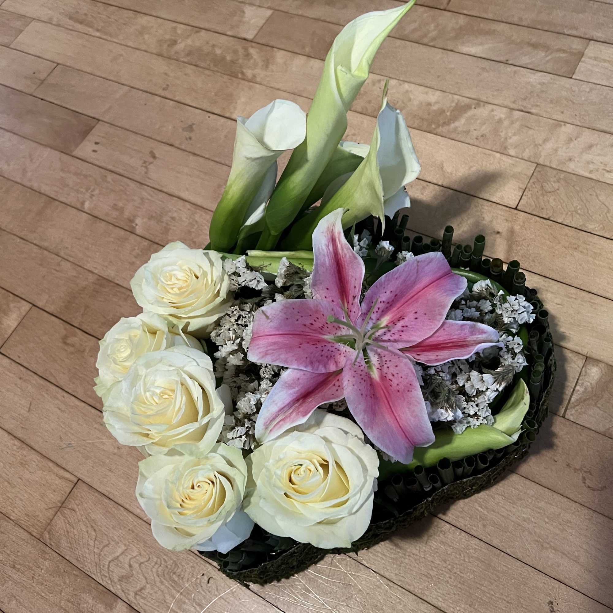Pink lily and white roses in a low floral arrangement