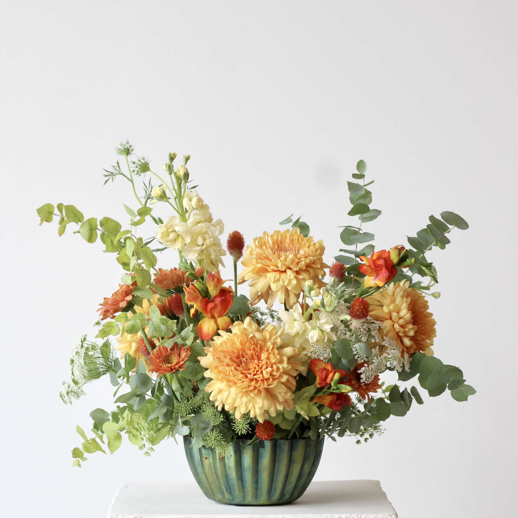 Meet &ldquo;Spring Oasis,&rdquo; a vibrant floral arrangement blending gold, fiery orange, and