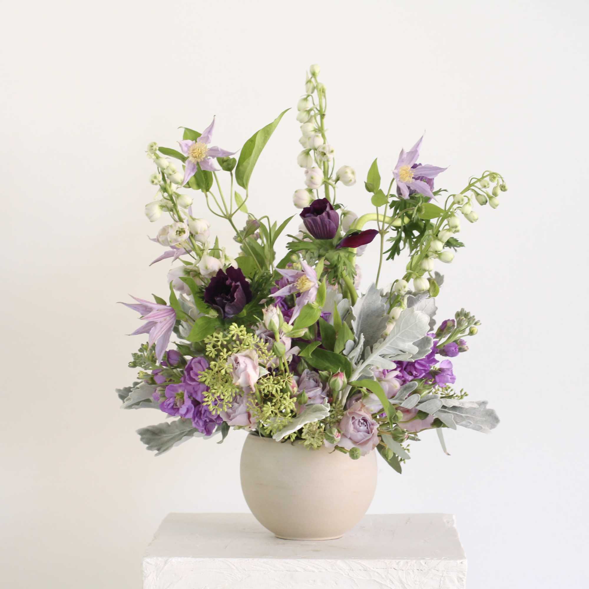 The Amethyst Arrangement features a balanced mix of soft lavender and deep