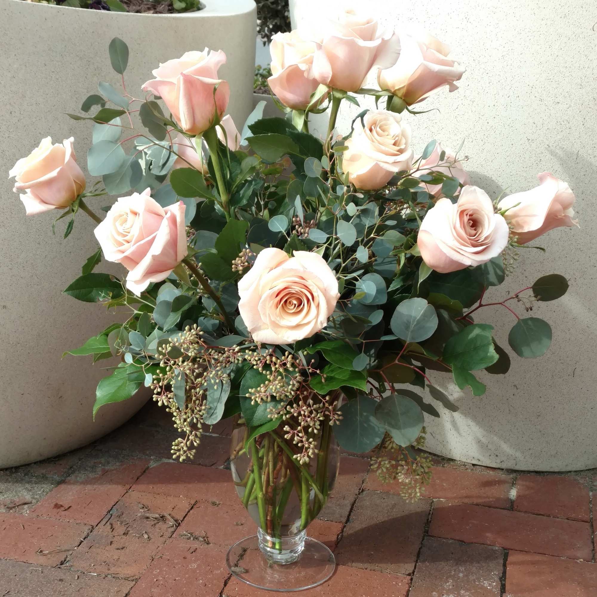 Bouquet of pale pink roses in a clear glass vase