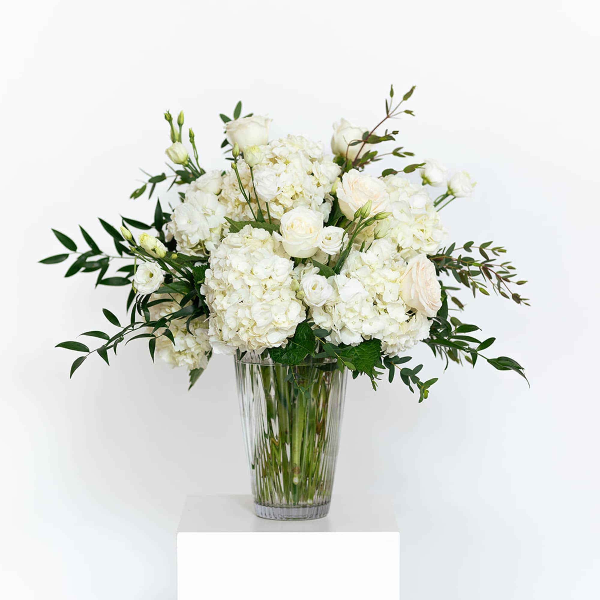 White floral arrangement in a clear glass vase