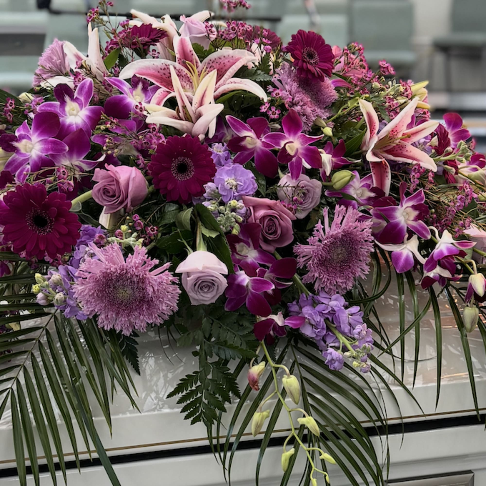 Large casket spray with pink and purple flowers