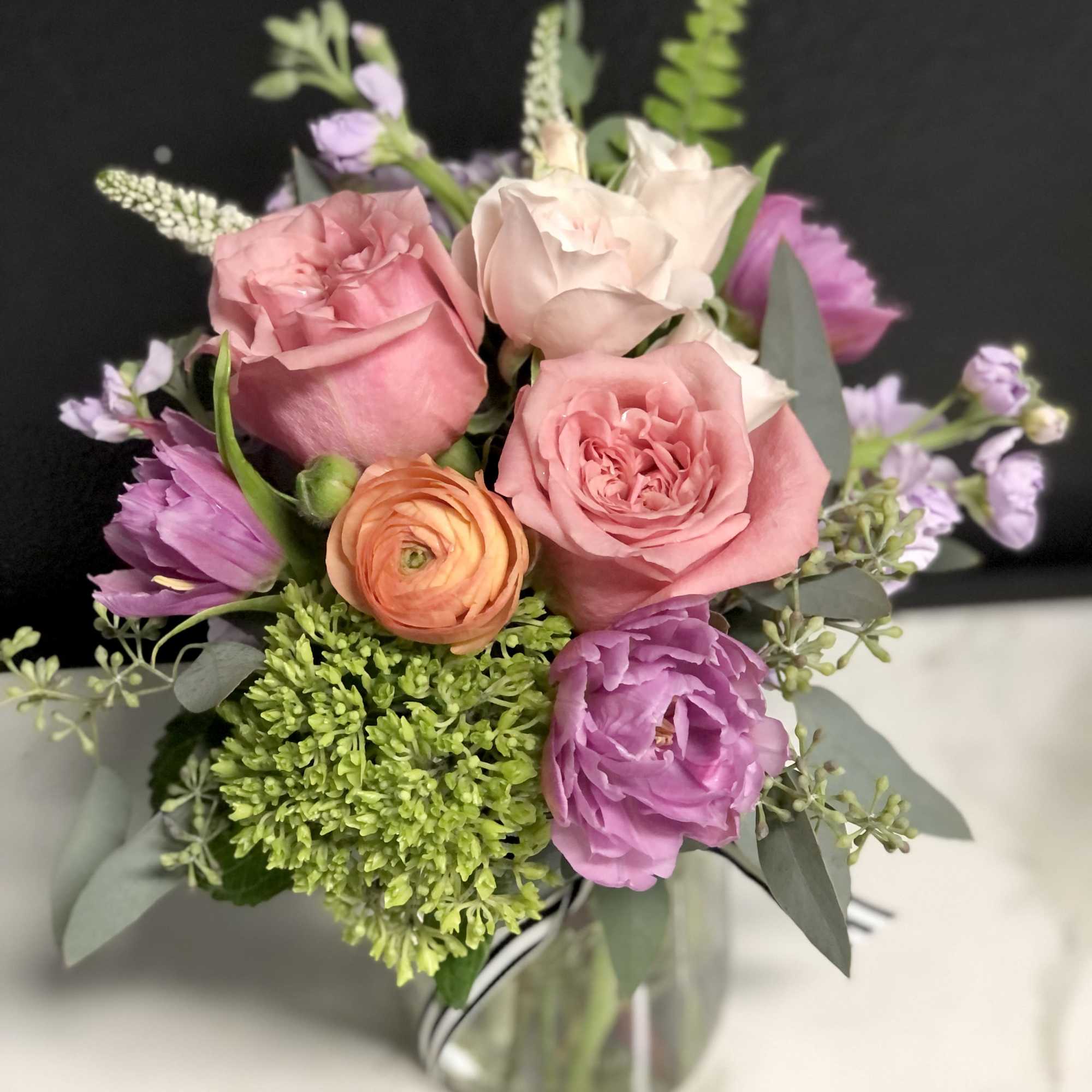 Pink and lavender bouquet in a clear glass vase