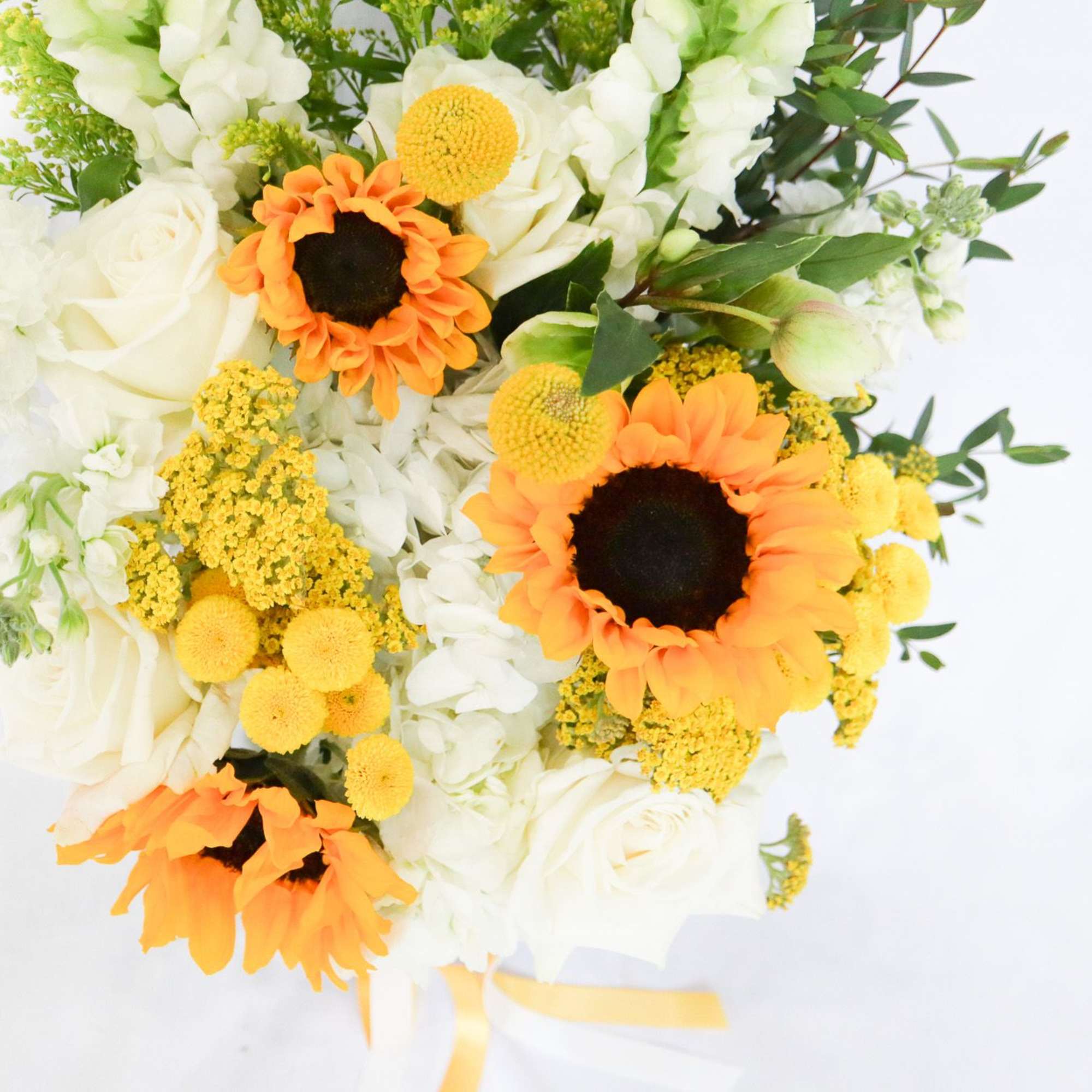 Bouquet of white roses and orange sunflowers with yellow accents