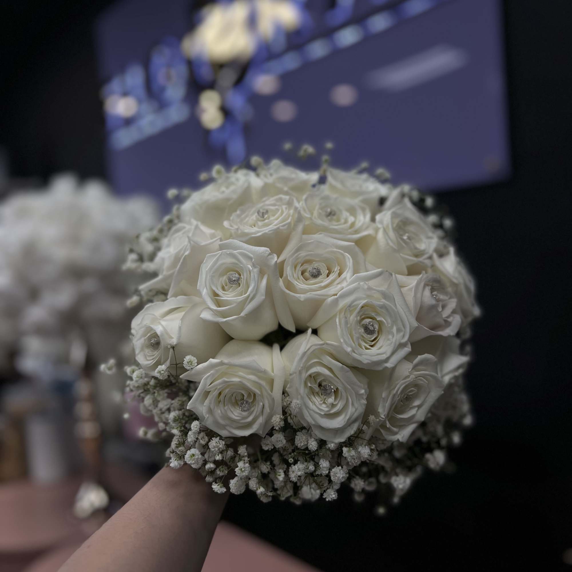An exquisite wedding bouquet composed entirely of pure white roses, symbolizing innocence