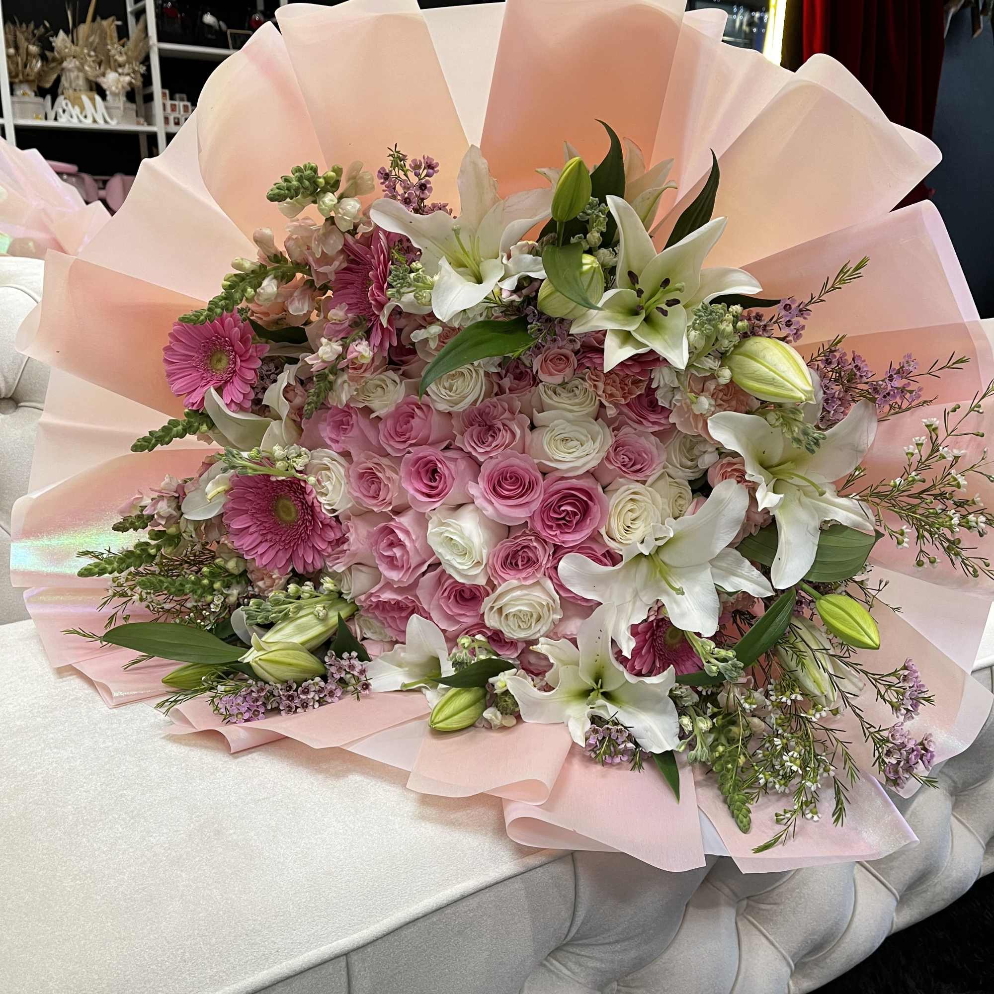This stunning arrangement features 35, 45, 55 elegant roses at its center
