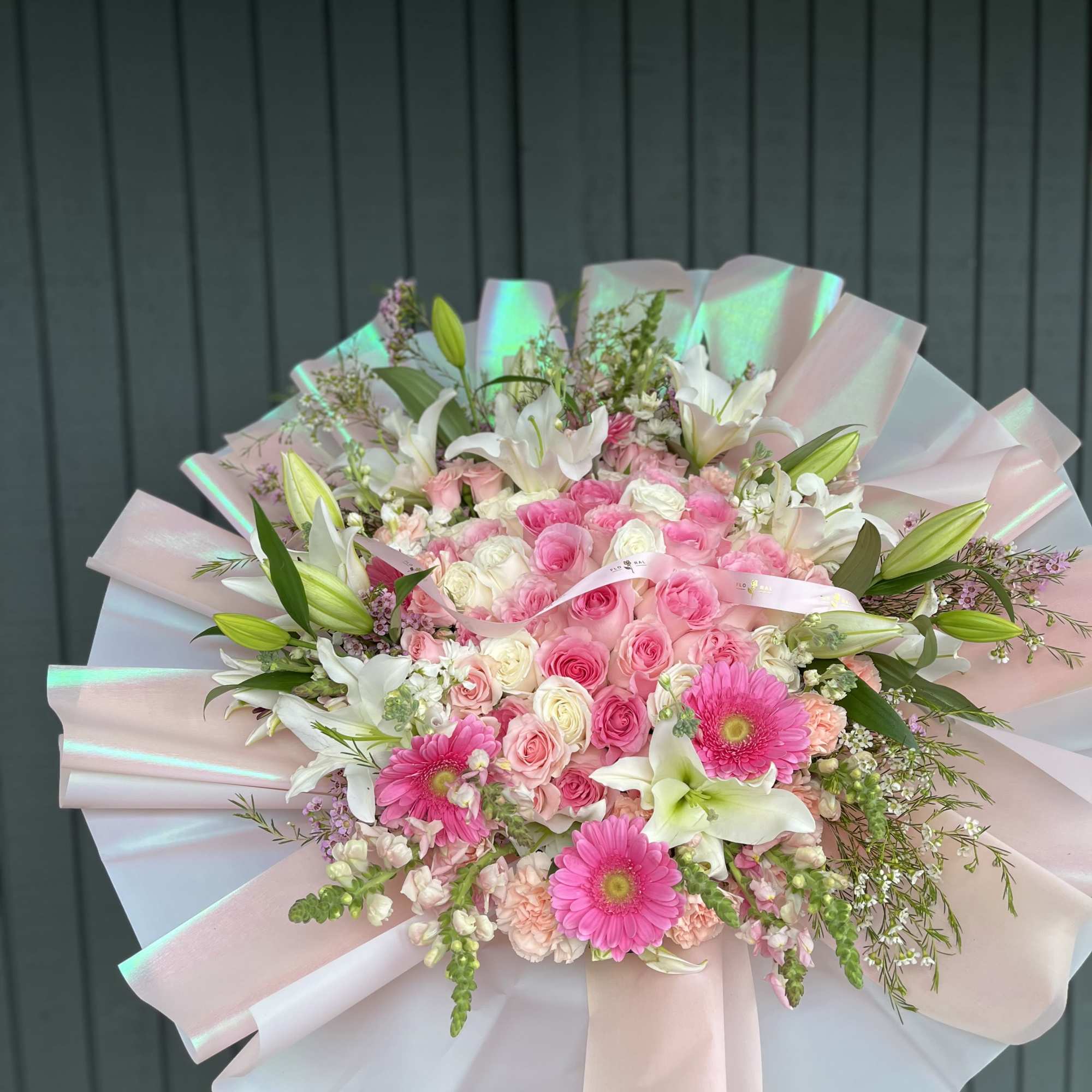 This stunning arrangement features 35, 45, 55 elegant roses at its center