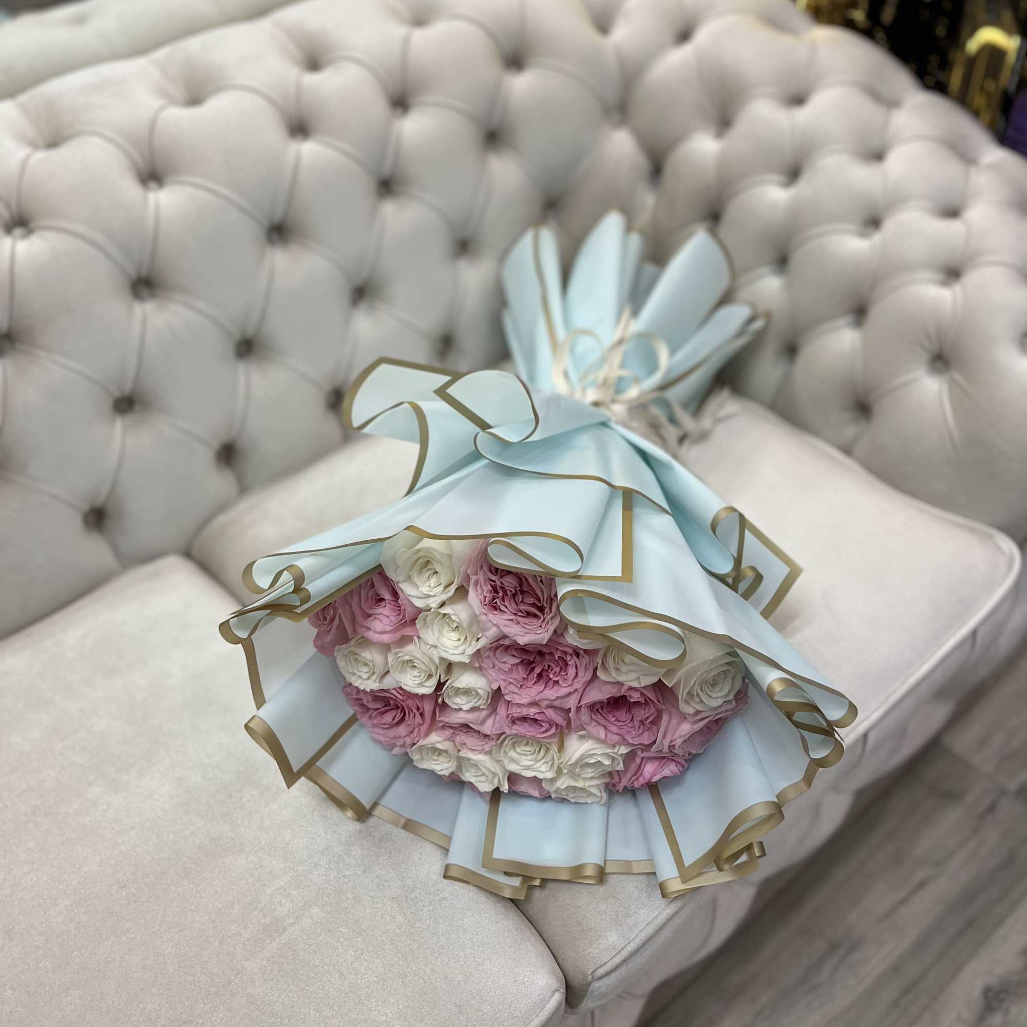 A delicate bouquet of 25 white and blush roses, symbolizing purity, love