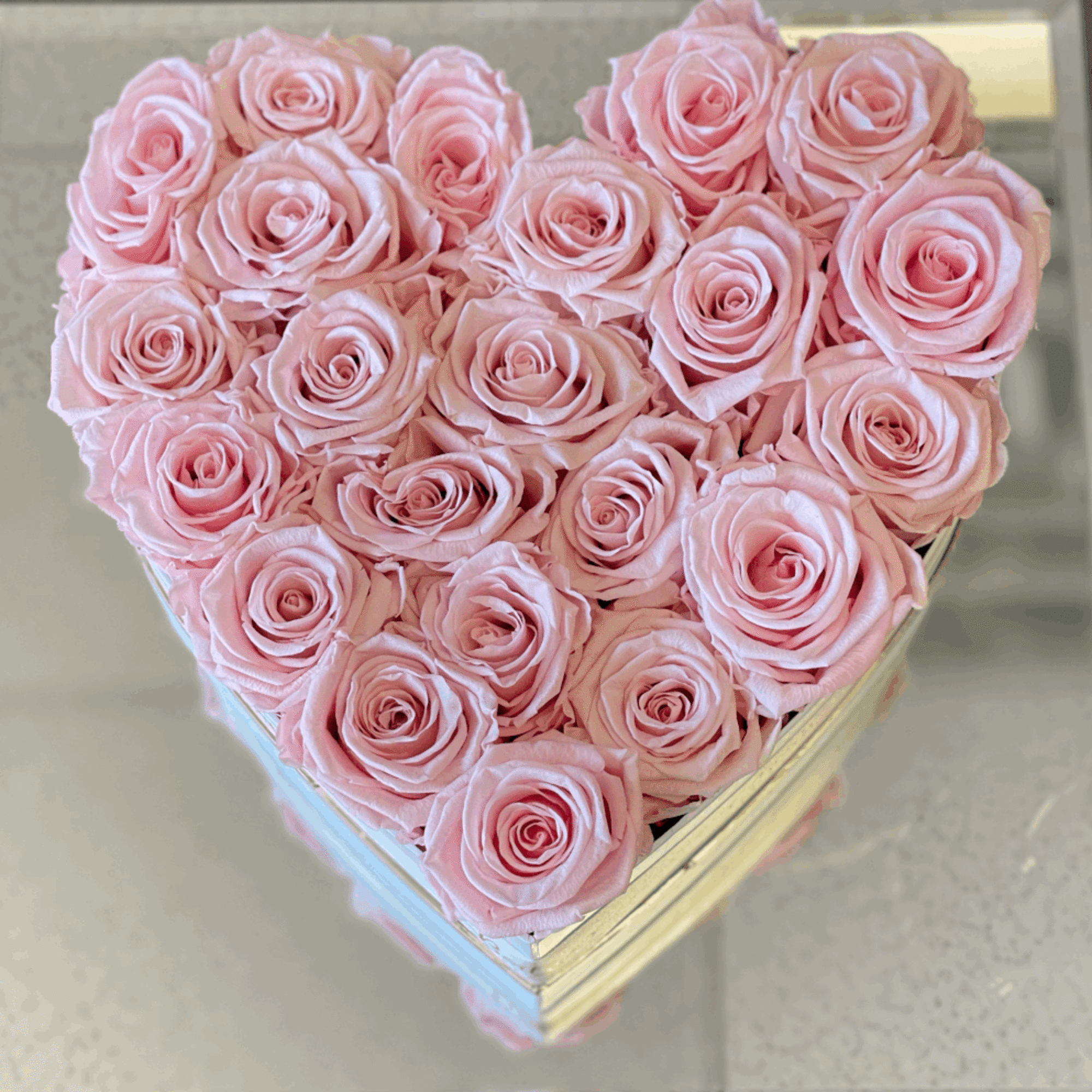 Heart-shaped box filled with pale pink roses