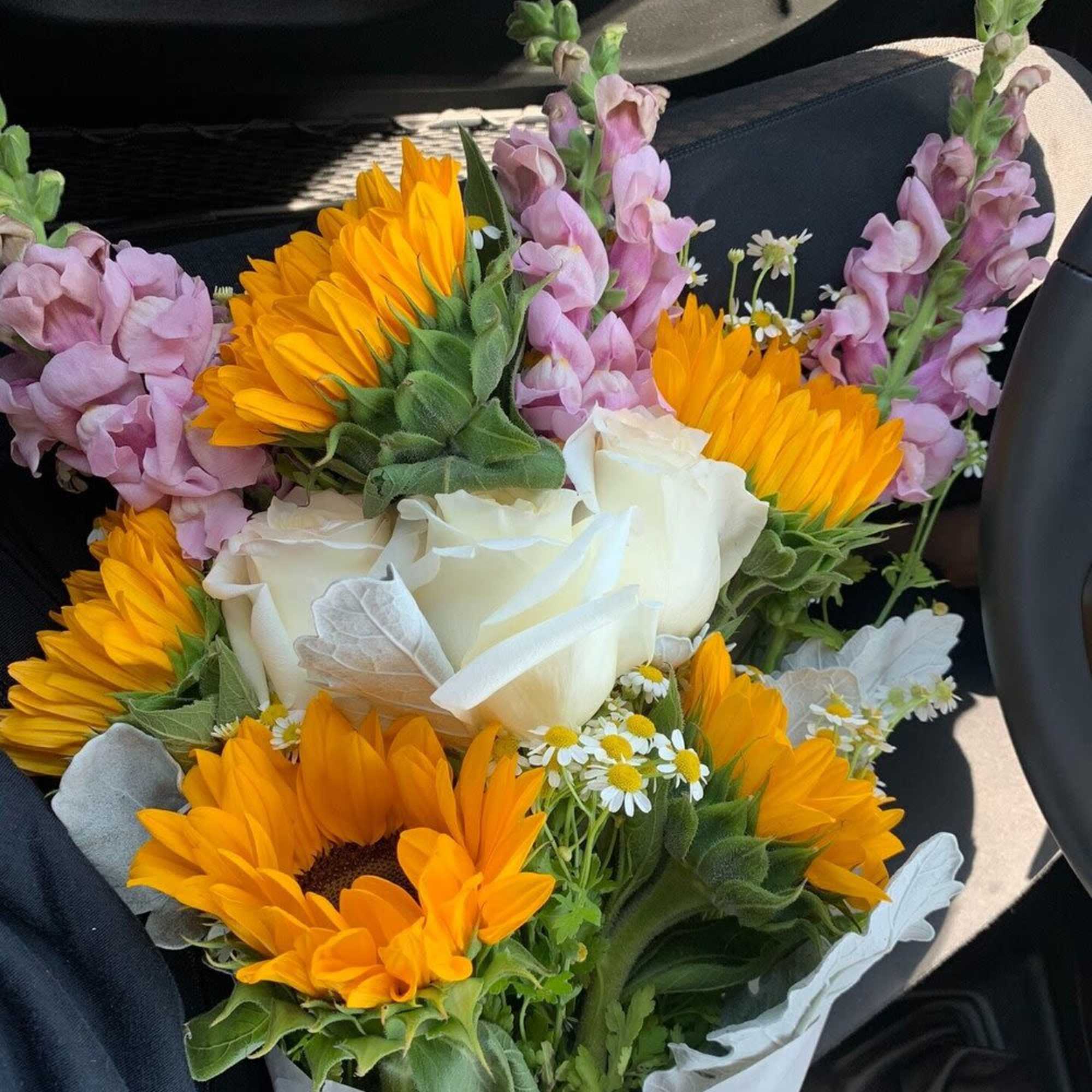 Bouquet of sunflowers, white roses, and pink snapdragons