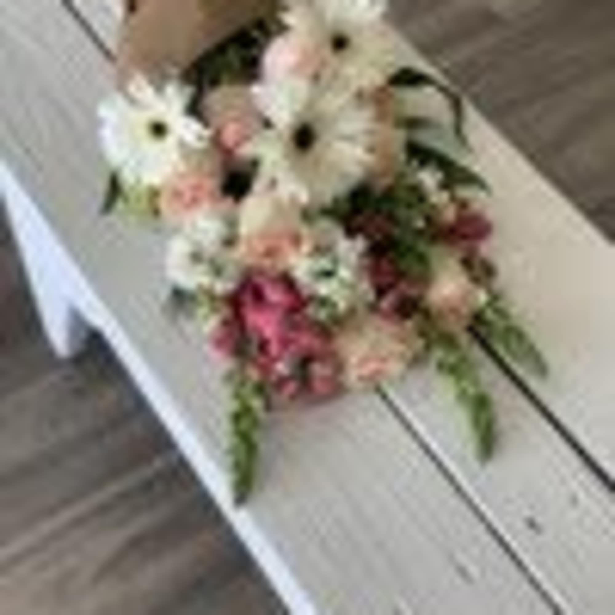Pink and white flower bouquet on a bench