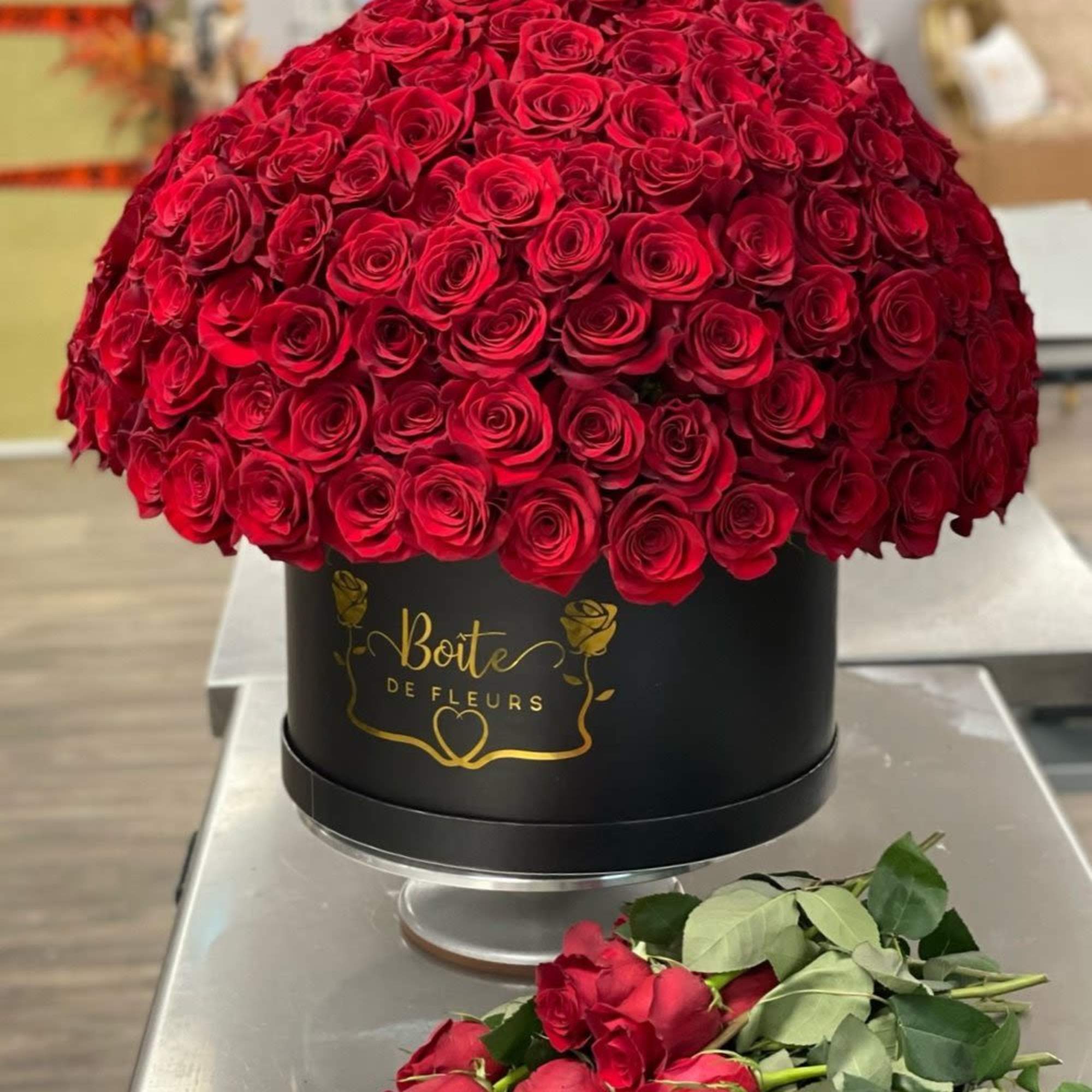 Large dome of red roses in a black round box