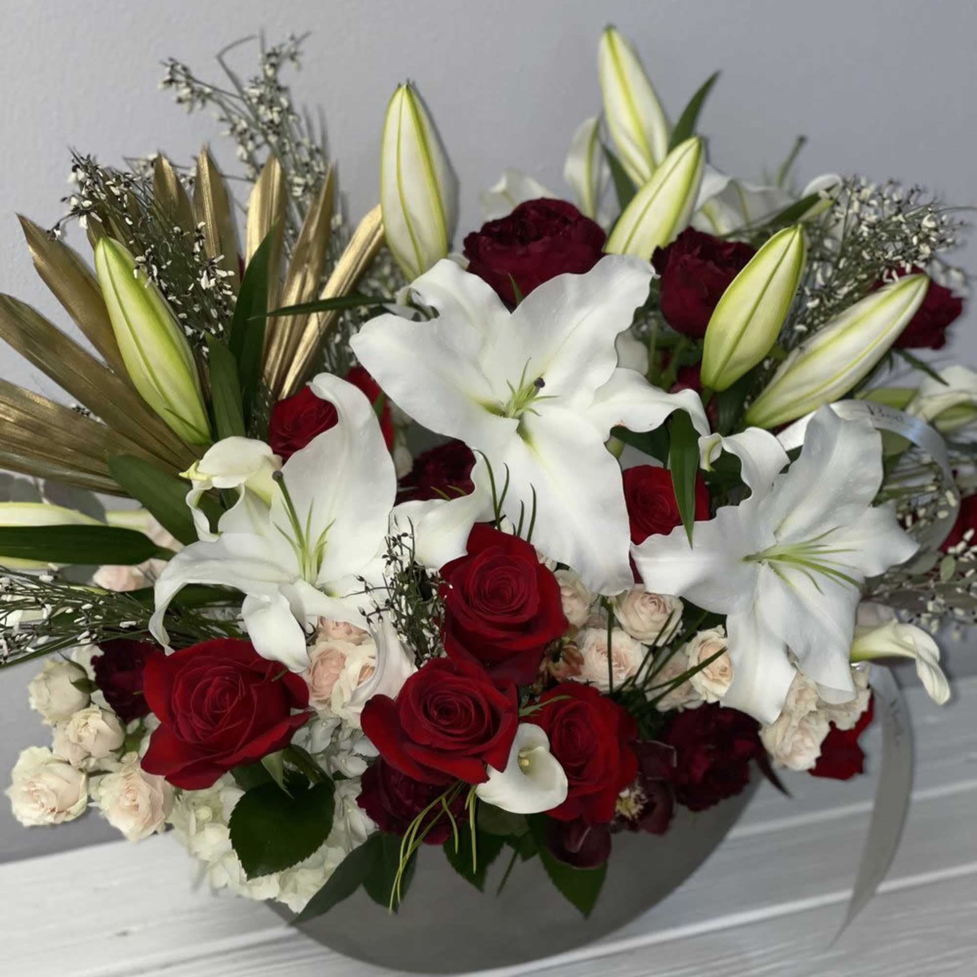 Red roses and white lilies in a gray vase