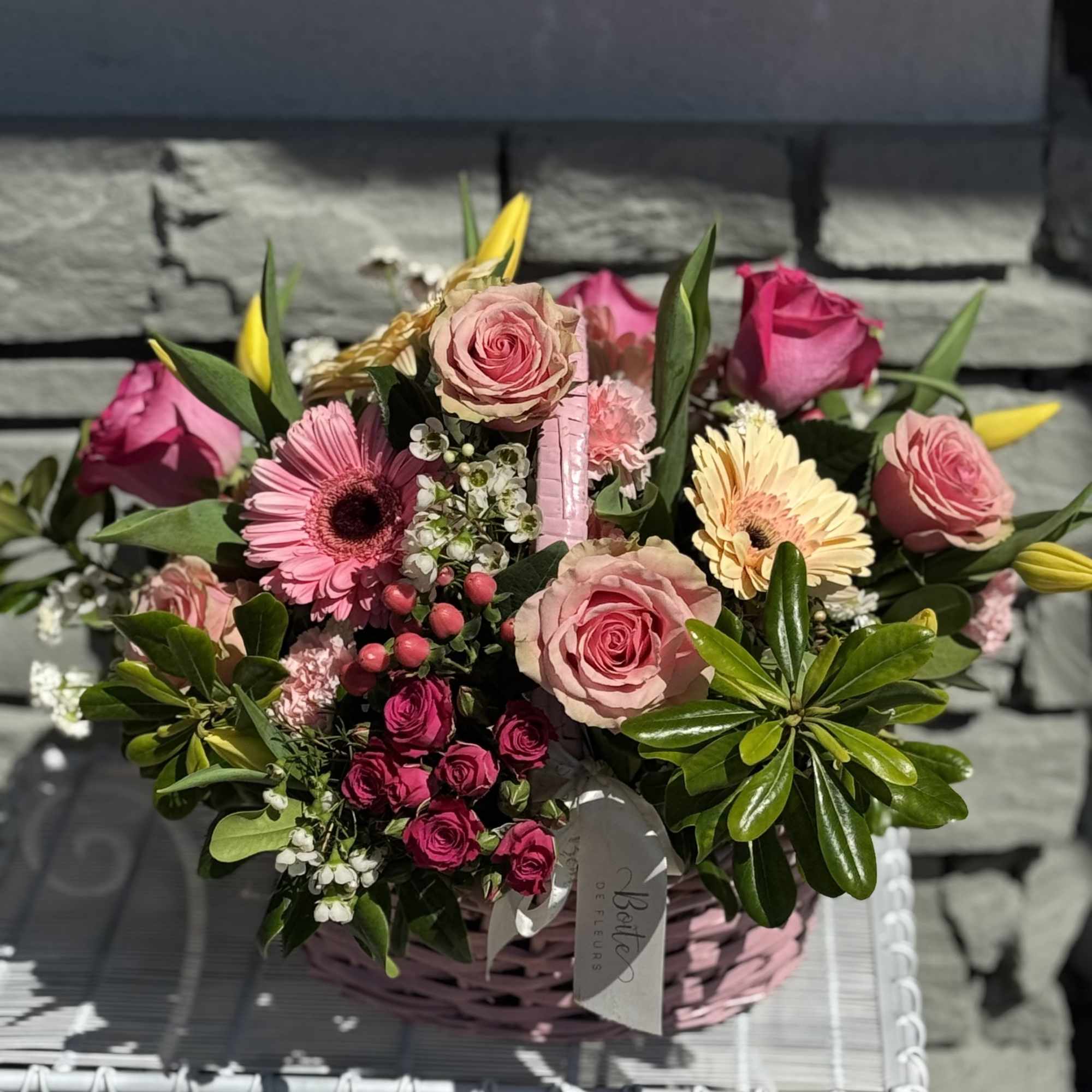 Pink rose and gerbera daisy bouquet in a pink basket