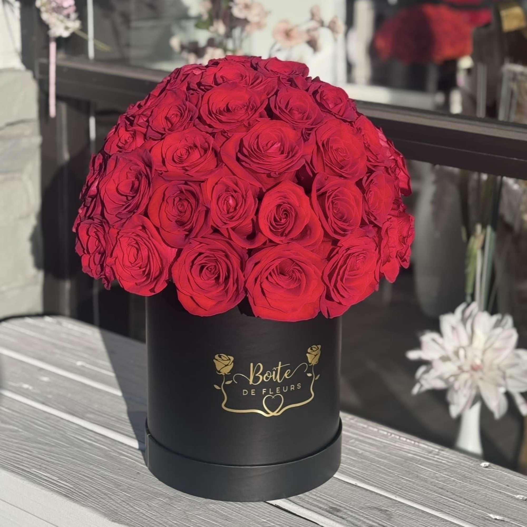 Red rose bouquet in a black round box