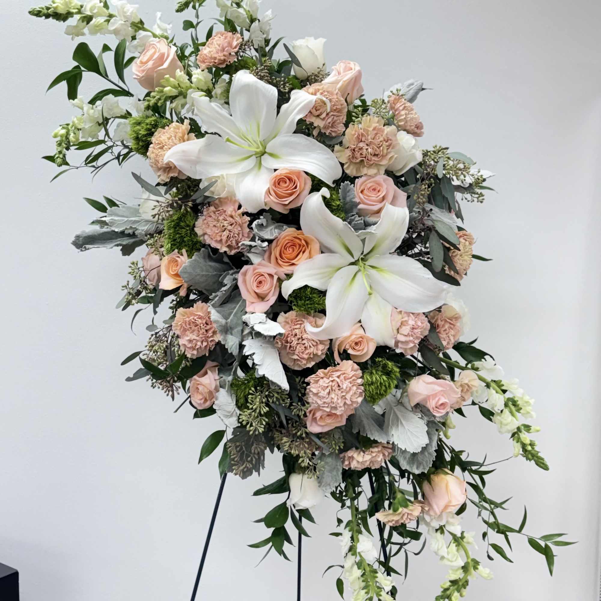 Large standing floral spray with white lilies and blush roses
