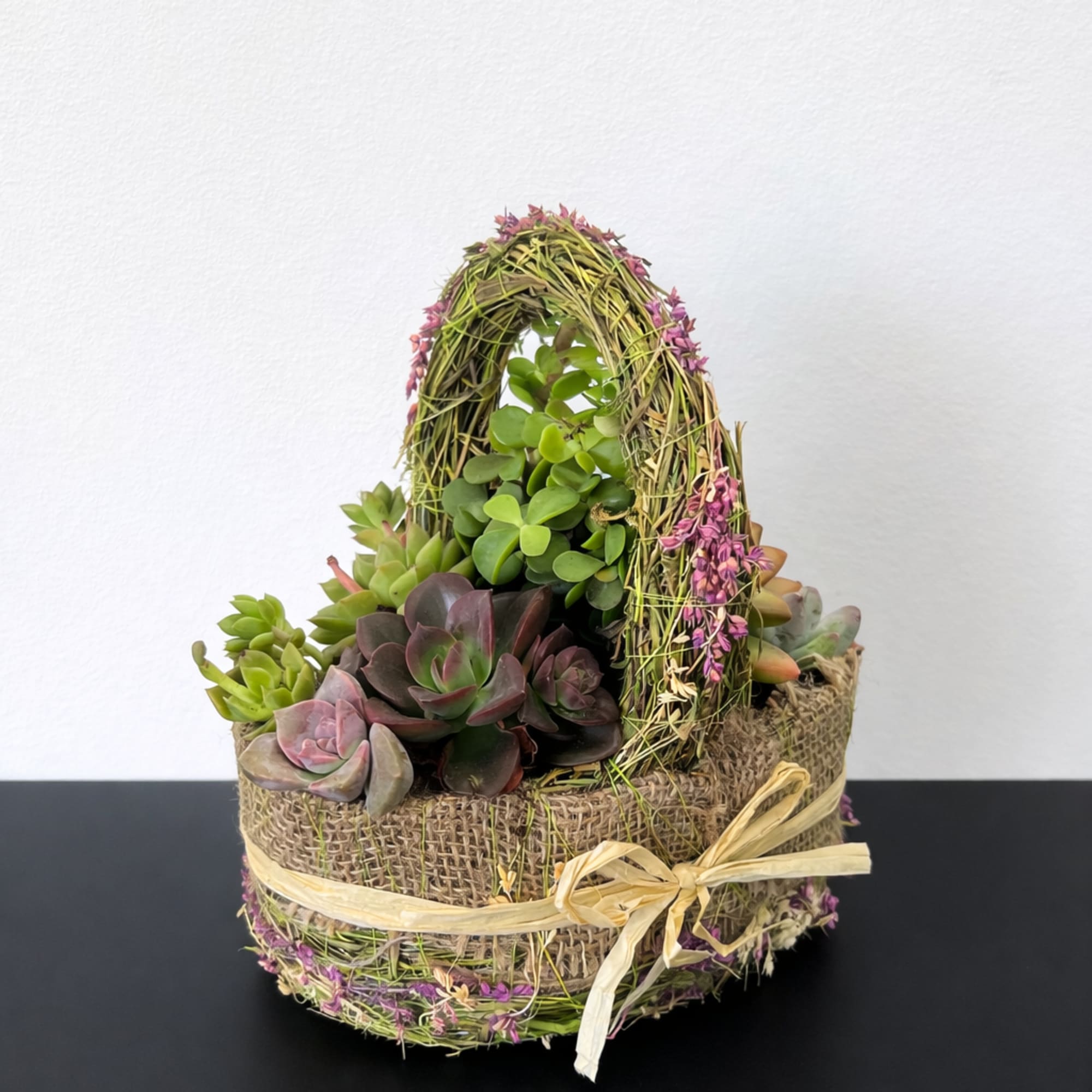 The sweetest little succulent basket styled in soft burlap with natural moss