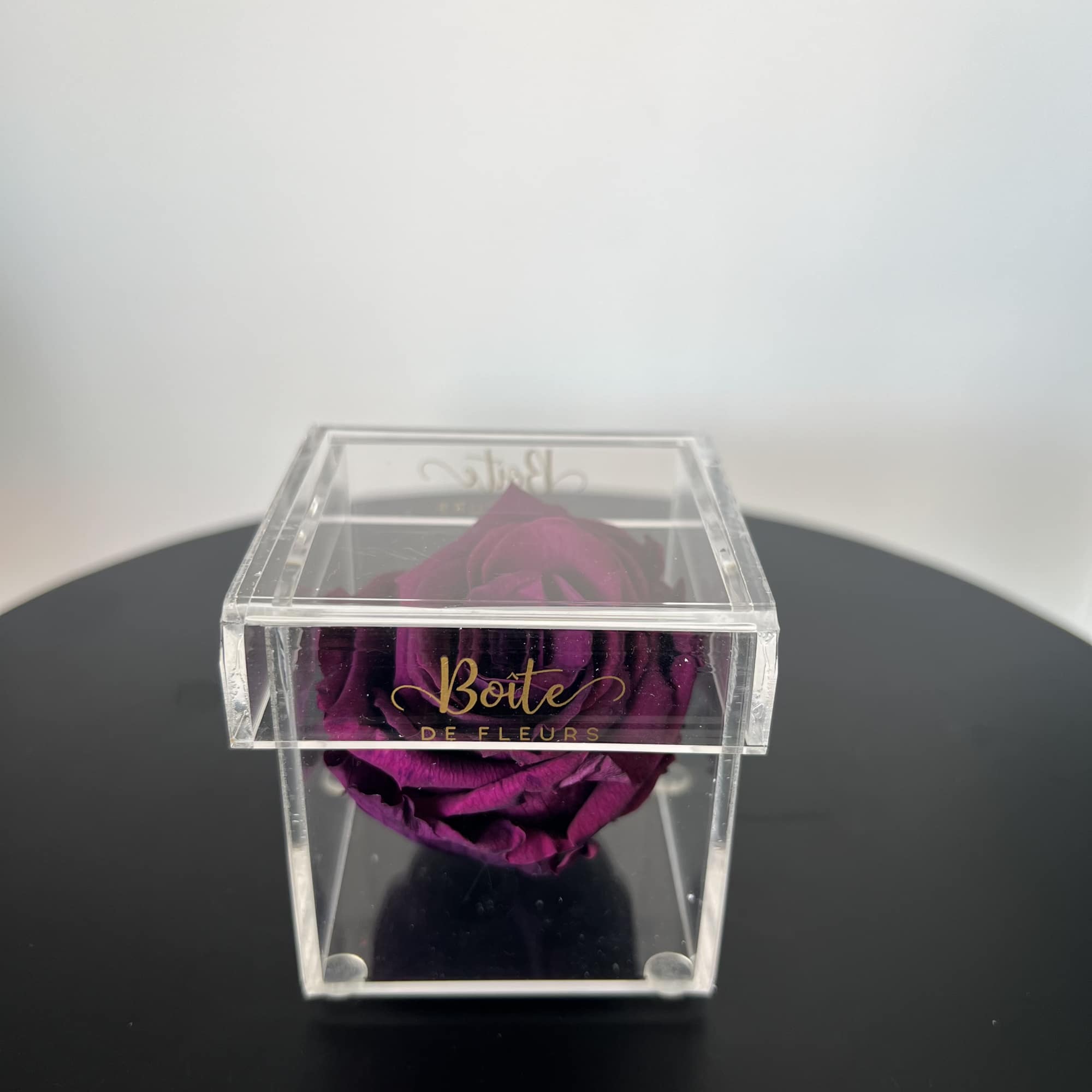 A single forever rose sits in a custom acrylic box. This petit, photo 2 of 2