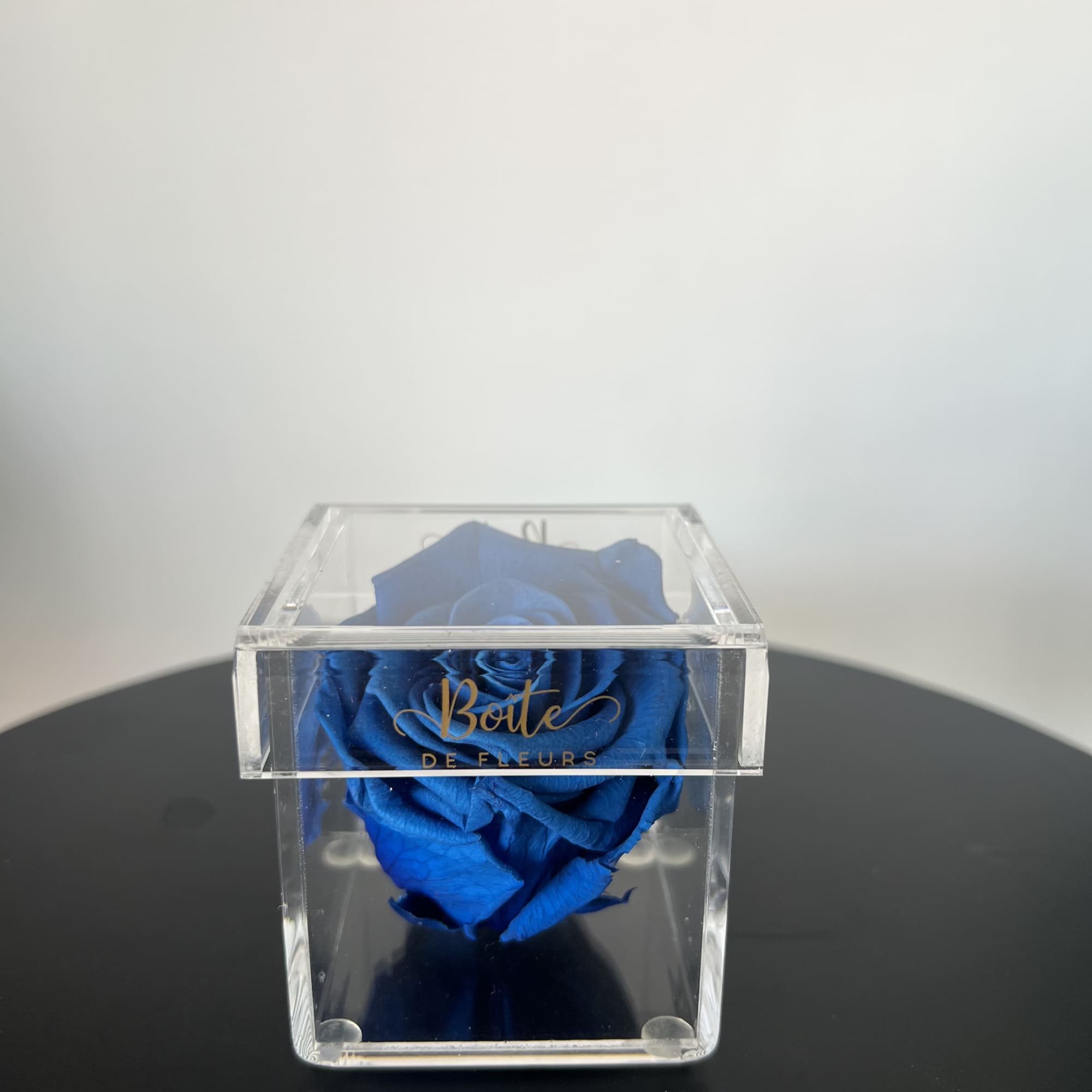 A single forever rose sits in a custom acrylic box. This petit, photo 2 of 2