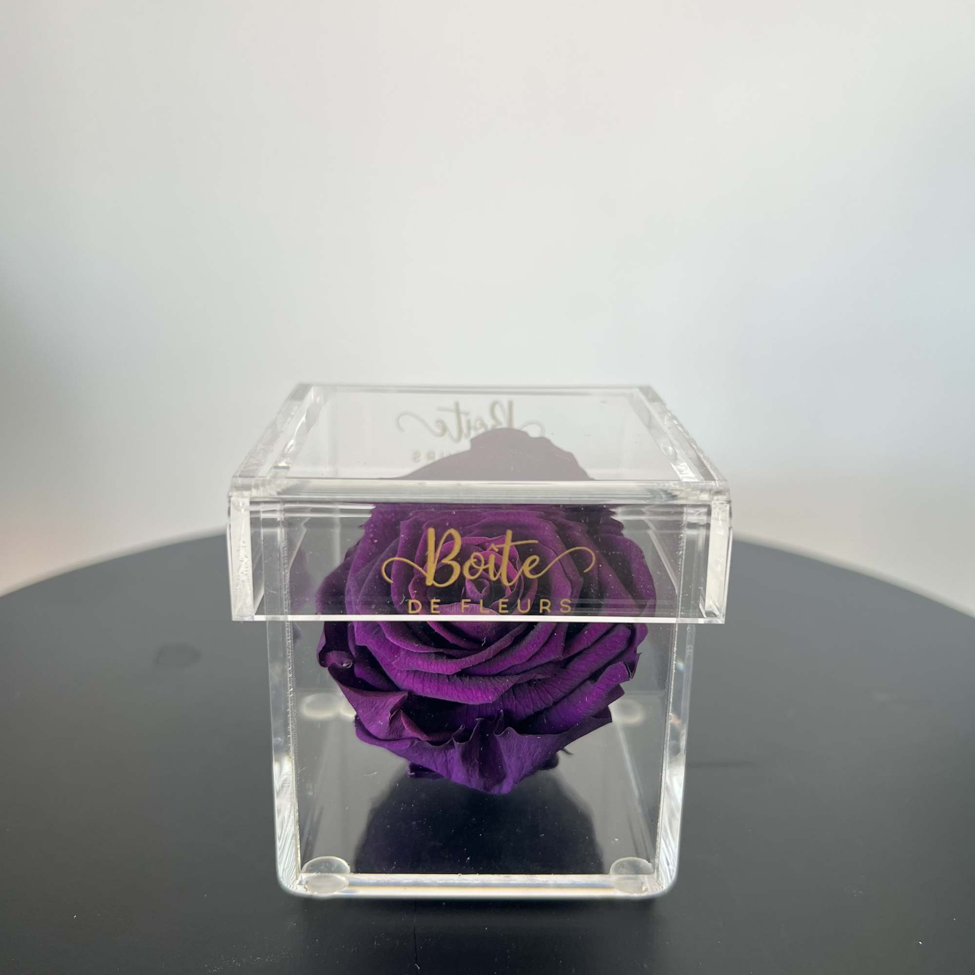A single forever rose sits in a custom acrylic box. This petit, photo 2 of 2