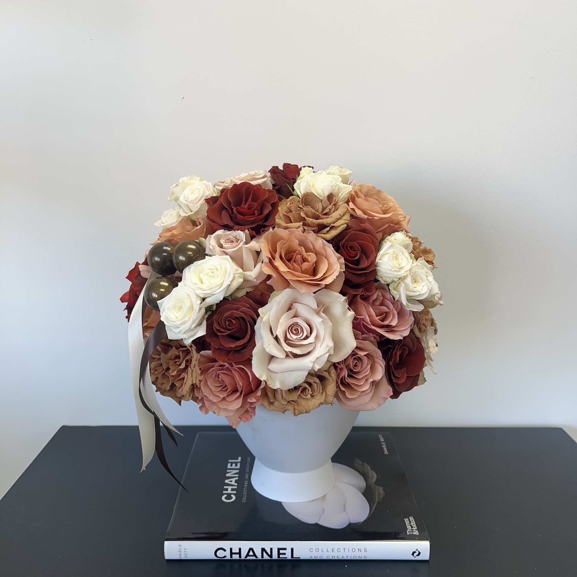 Cashmere Kiss is a luxurious rose arrangement featuring elegant shades of brown