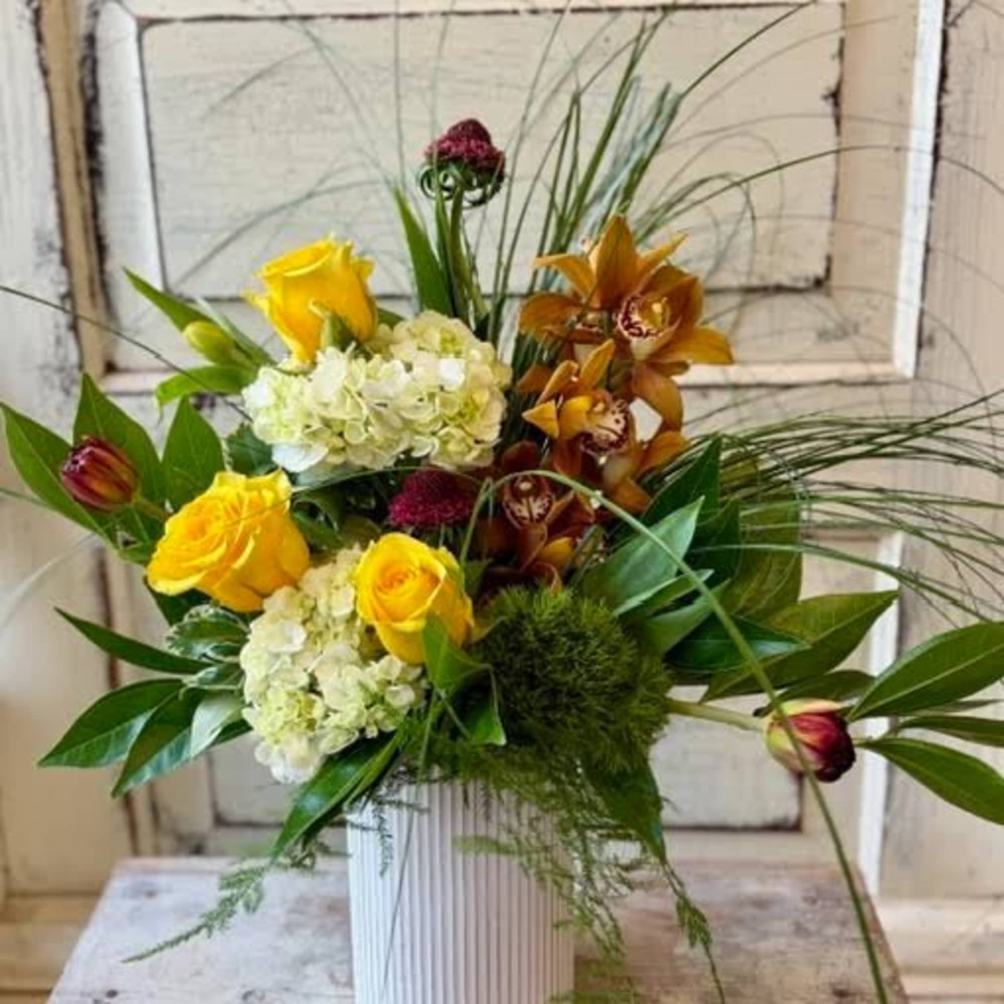 This modern  arrangement in a corrugated metal pot lets the unusual
