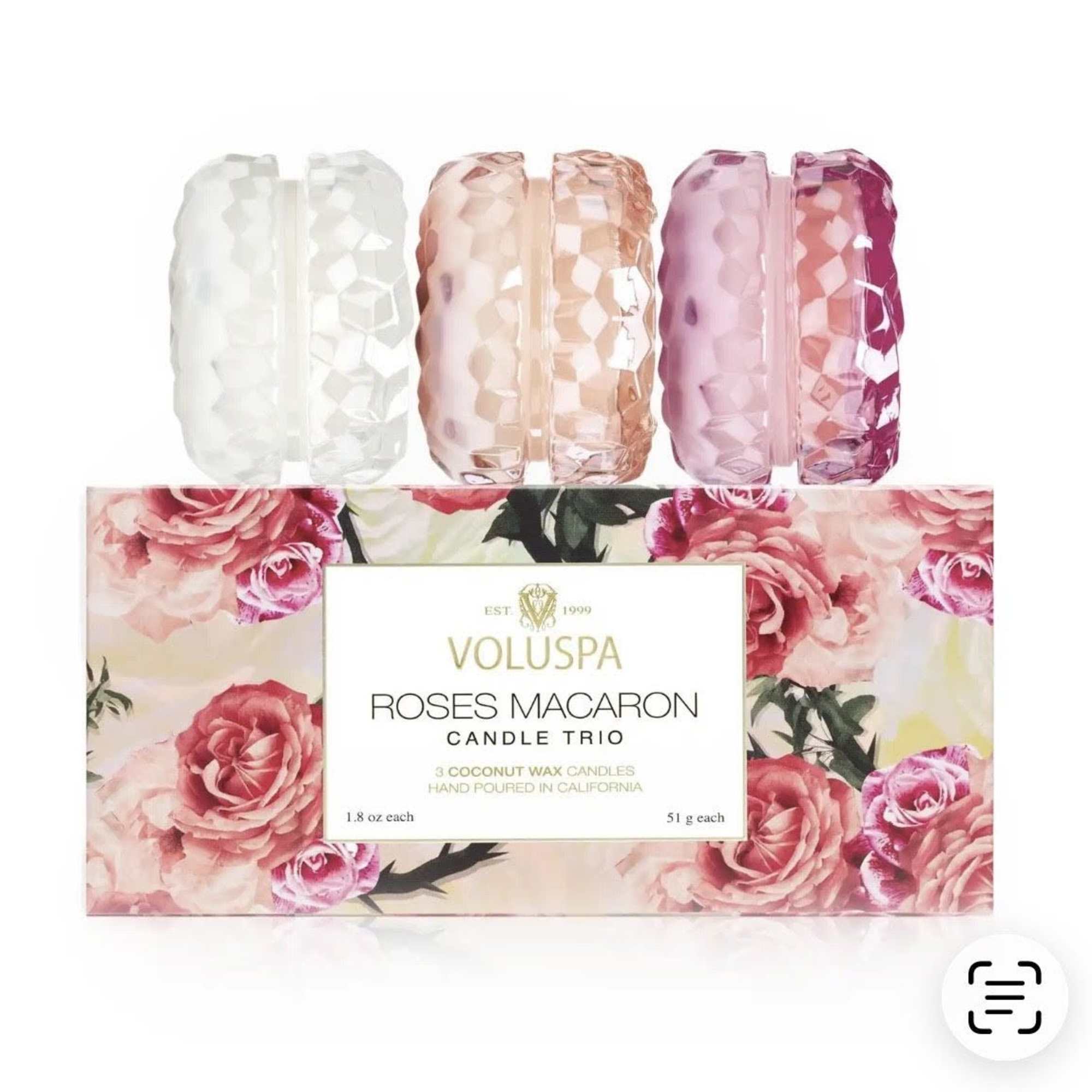 Three rose-scented candles in faceted glass holders with floral packaging
