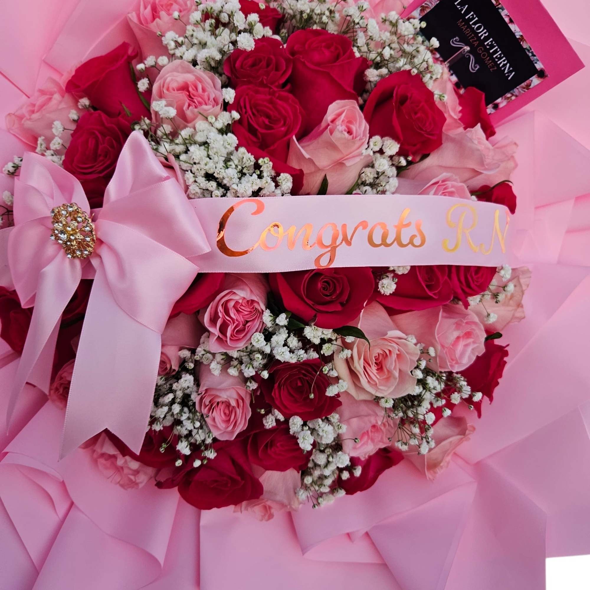 A lush cascade of red and blush-pink roses says celebration the moment, photo 2 of 2