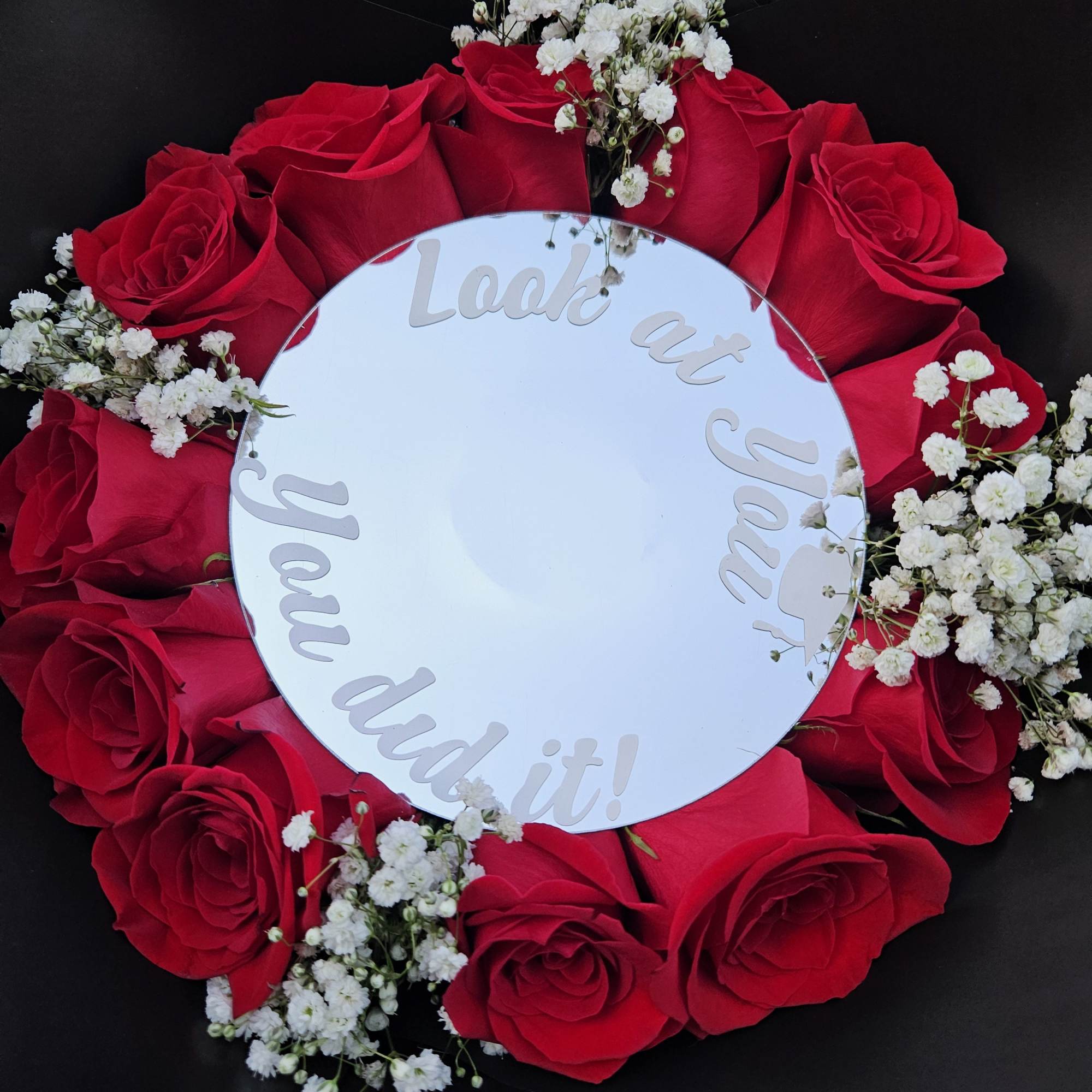 A bold ring of vivid red roses framed by delicate white baby's, photo 2 of 3