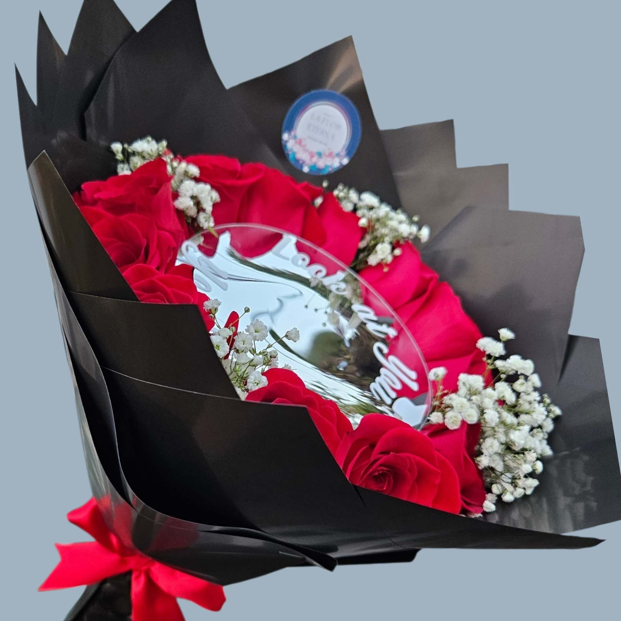 A bold ring of vivid red roses framed by delicate white baby's, photo 3 of 3
