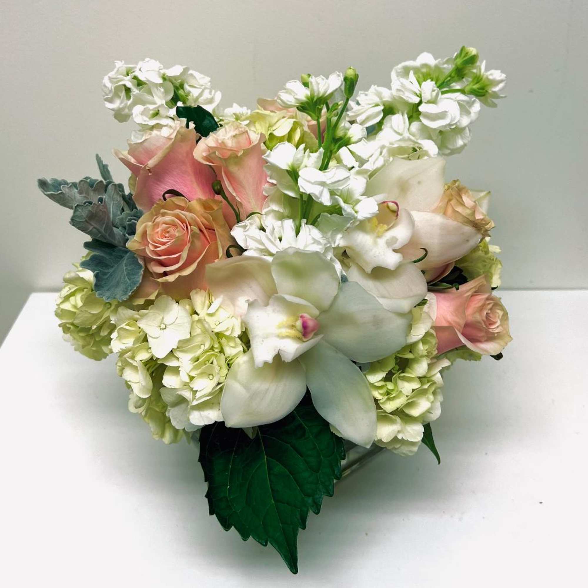 Bouquet of pale pink roses, white orchids, and white hydrangeas