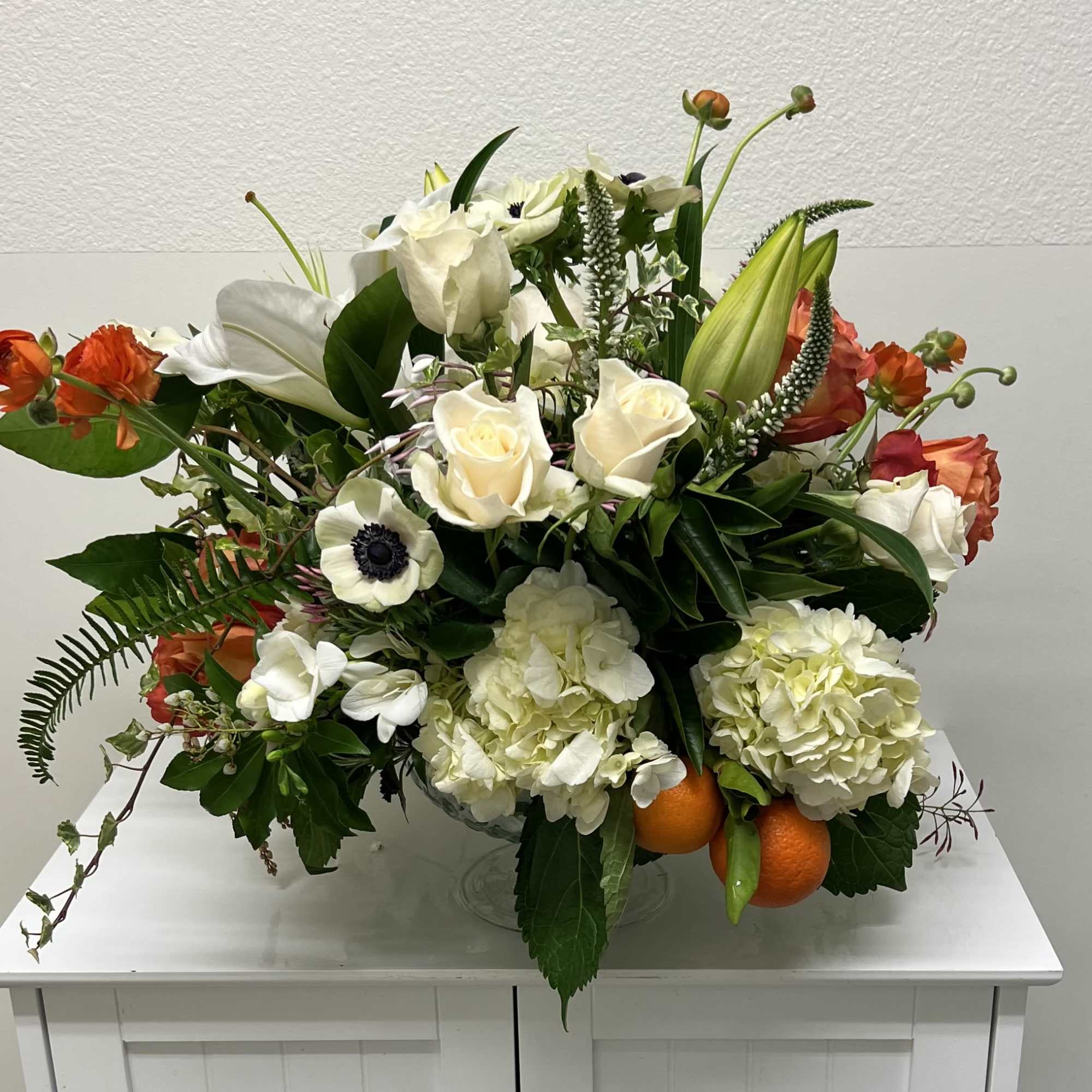 A serene palette of creamy whites punctuated by warm orange and soft