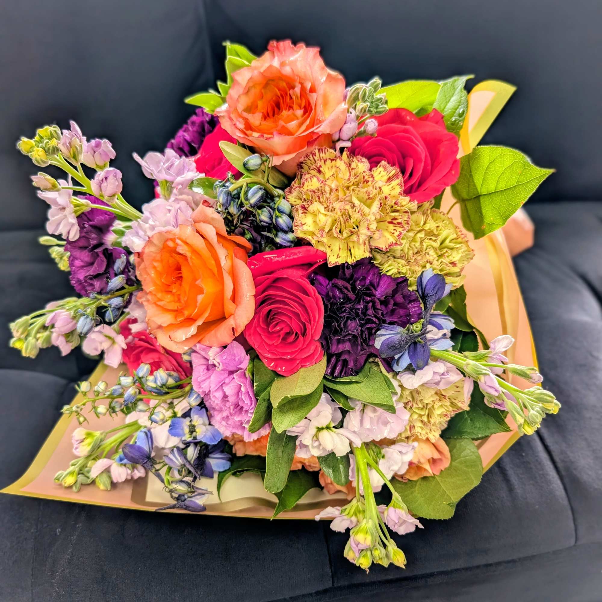 Mixed bouquet of orange, pink, purple, and yellow flowers
