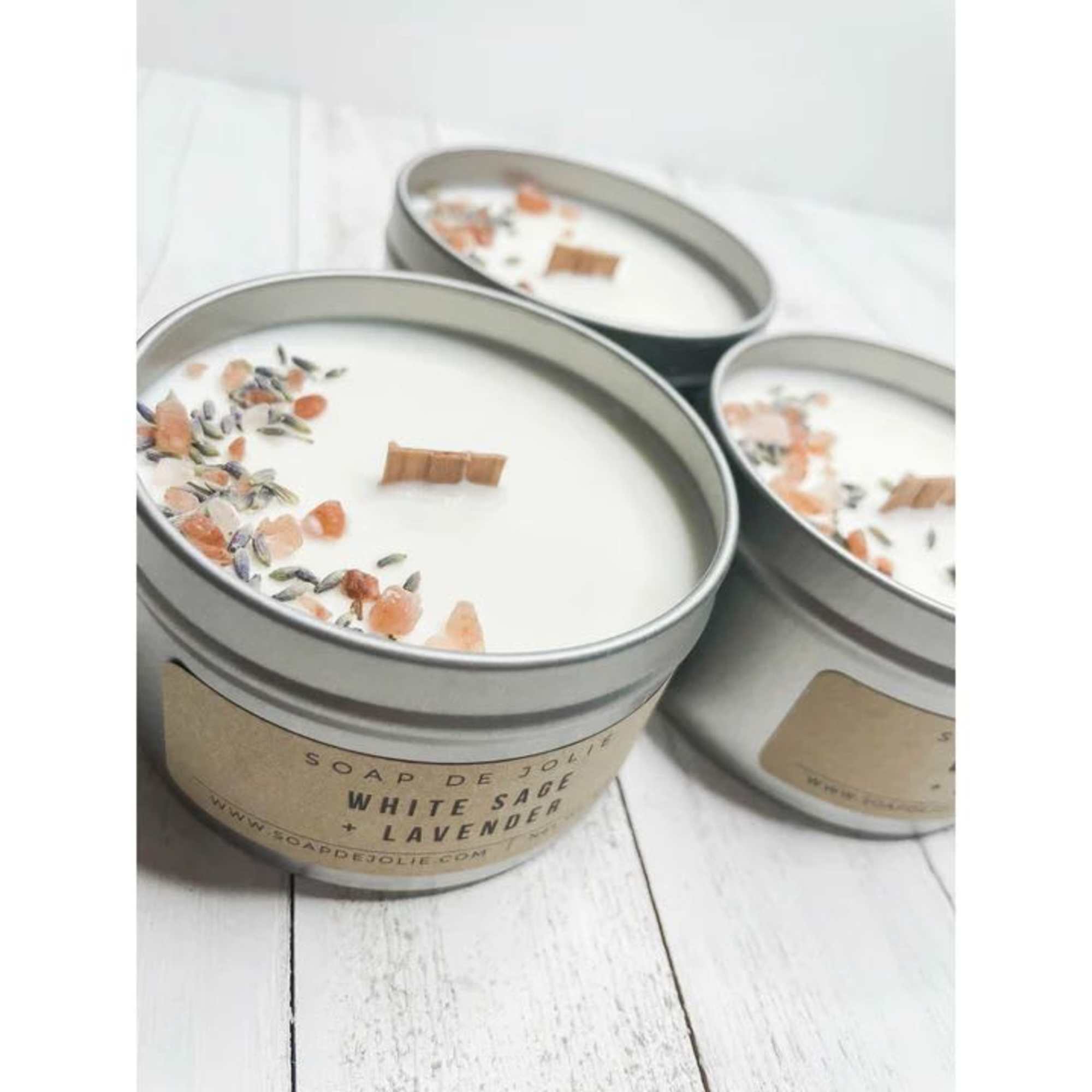 Three tin candles with white wax and floral topping