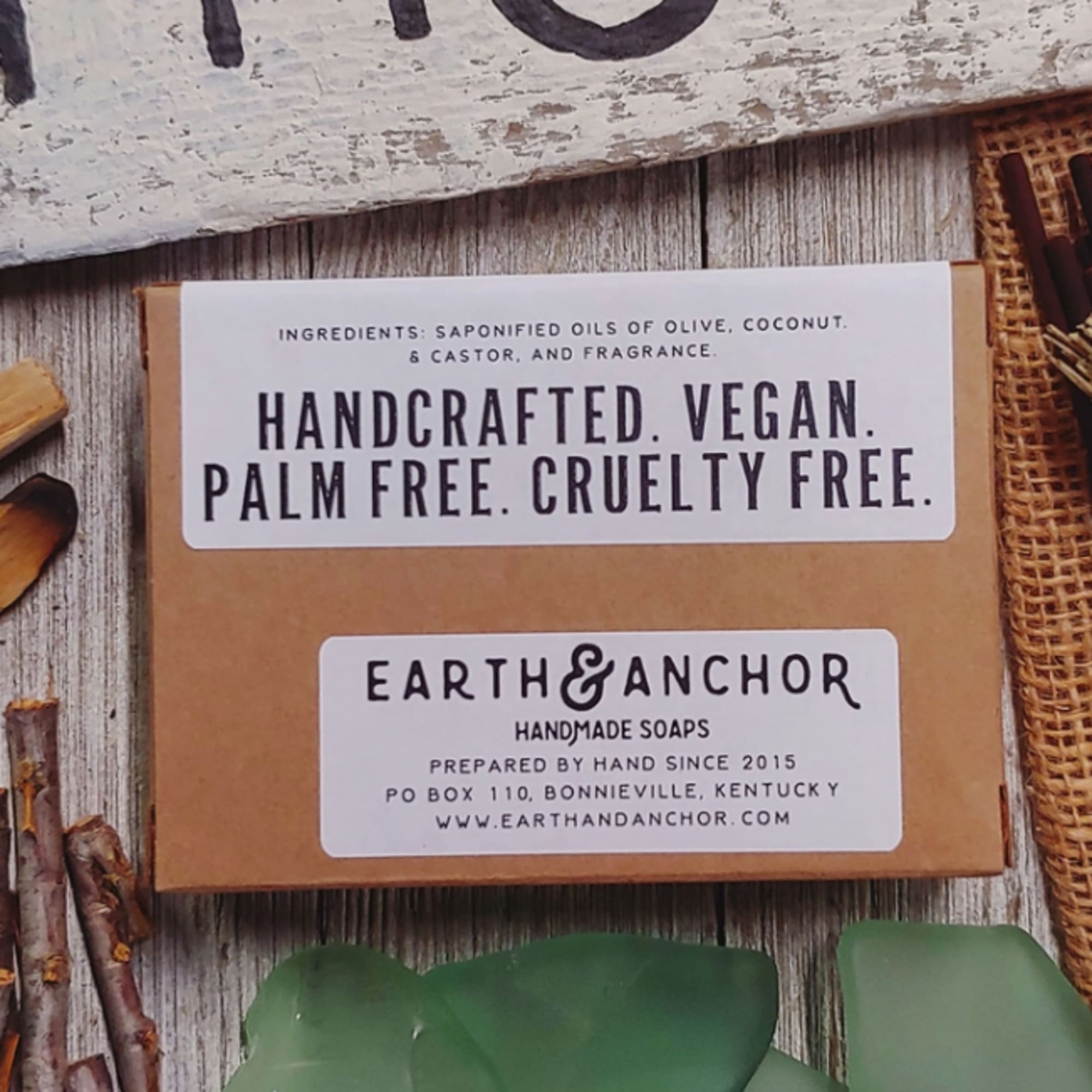 Boxed handmade soap with labels on a rustic wooden surface