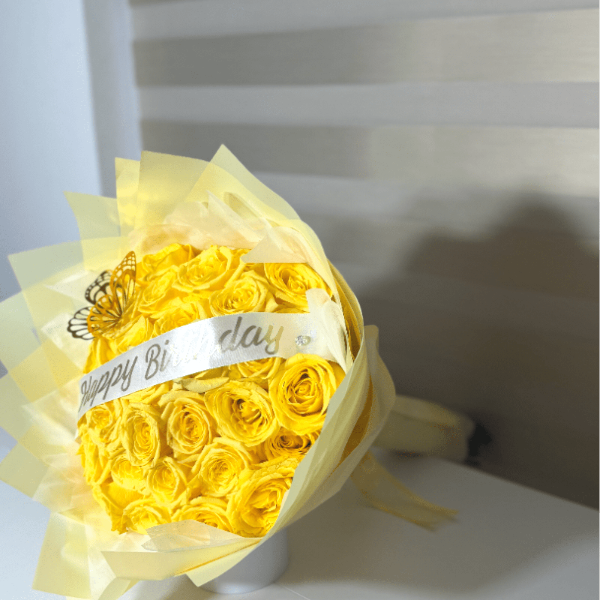 Luxury birthday bouquet featuring premium yellow roses, elegant wrapping, and a Happy