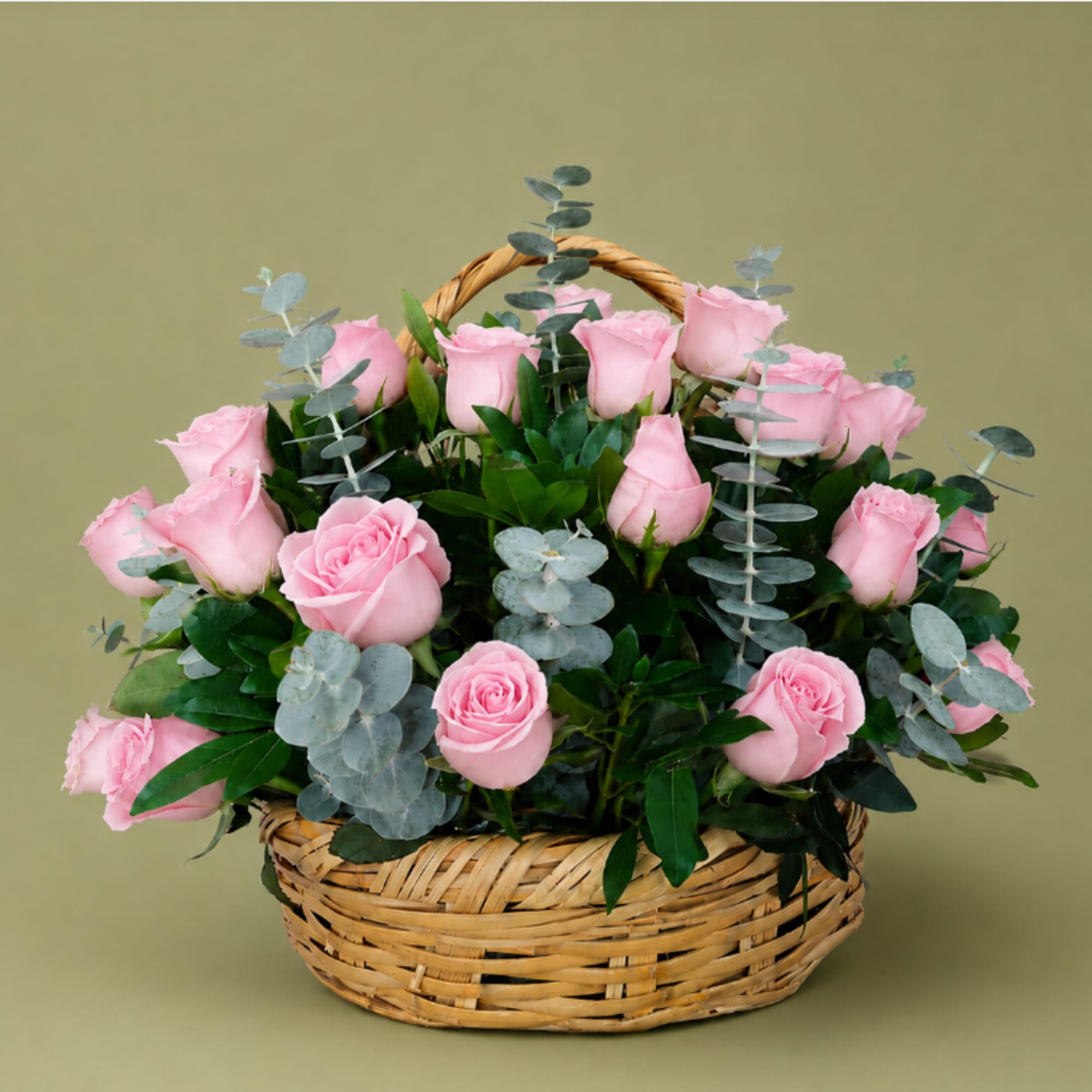 Basket of pink roses with silvery eucalyptus
